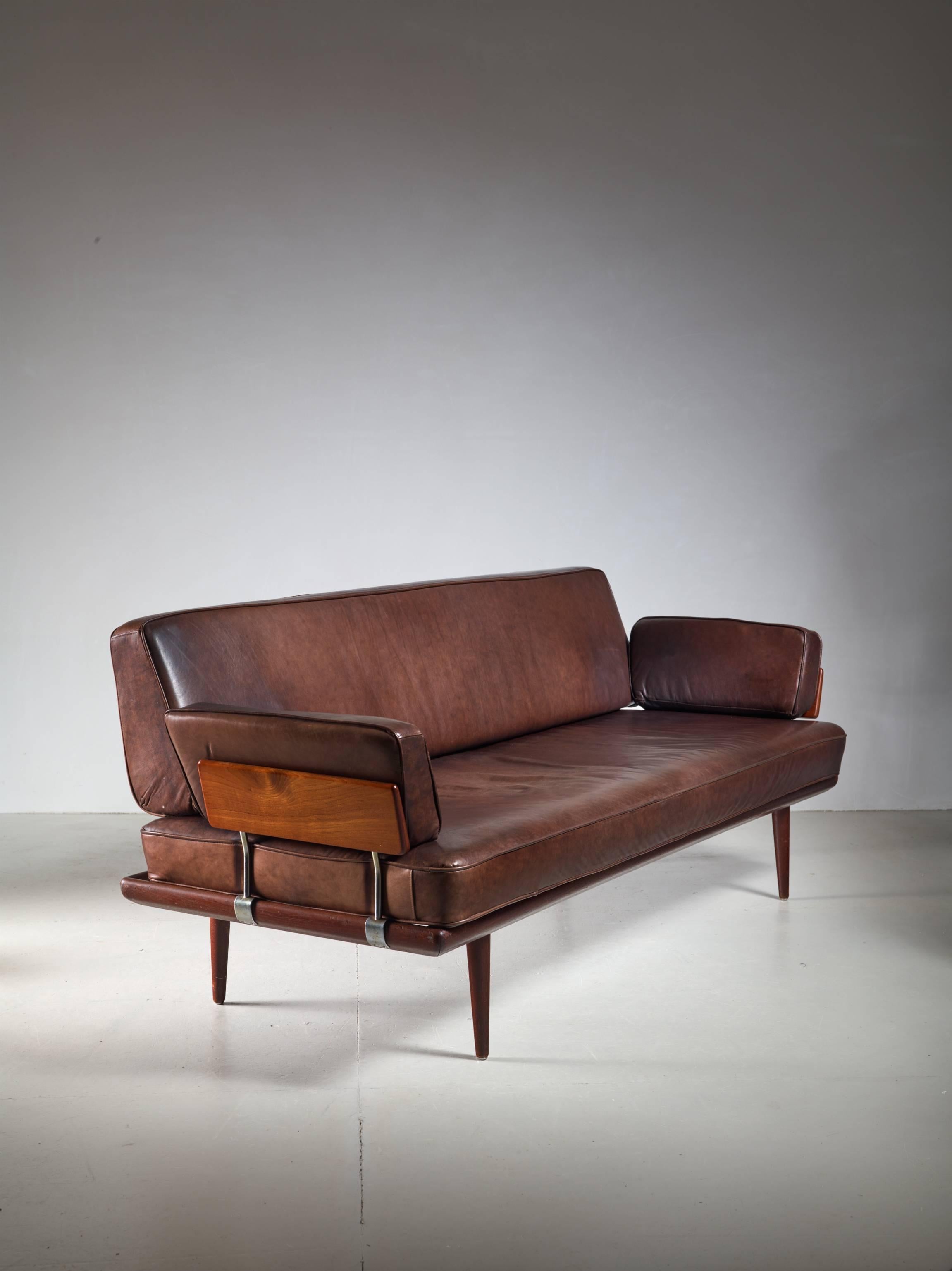 A model 'Minerva' sofa by Peter Hvidt & Orla Mølgaard Nielsen for France & Søn. Beautiful tapering legs and removable armrests and backrest.
The frame is in an excellent condition with minor signs of usage and the chocolate brown leather is