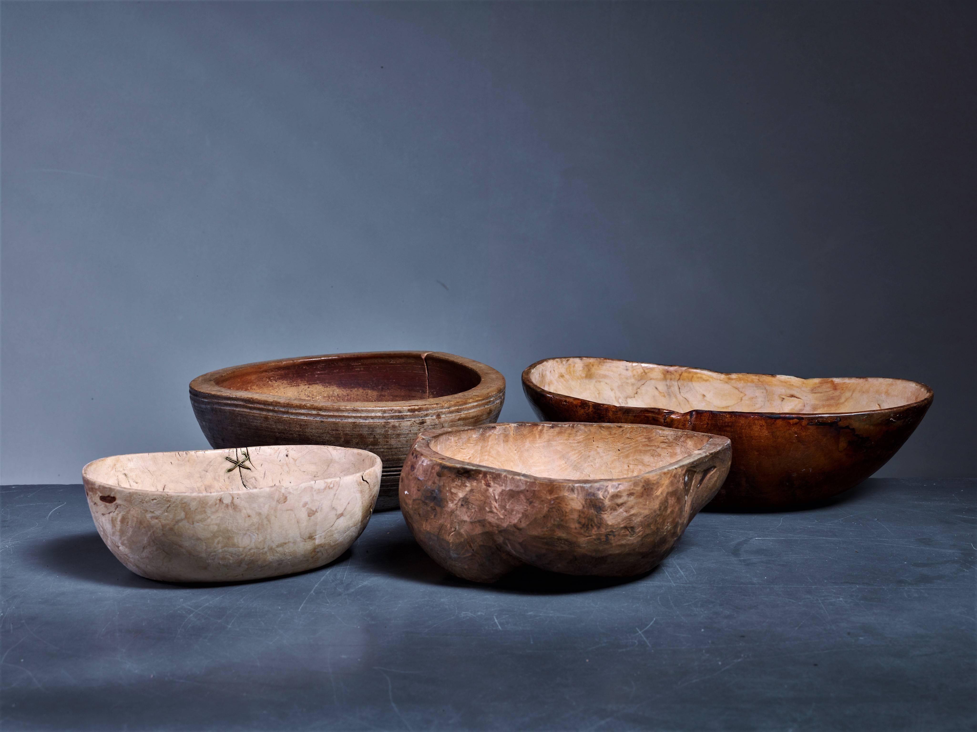 A set of four 19th century Folk Art wooden bowls from Sweden.

The two round bowls have a 23/24 cm (ca. 9 inch) diameter and are 9/10 cm (circa 3.5 inch) high. The other smaller bowl is 20 by 14.5 cm (8 by 5.5 inch) and is 7 cm (2.8 inch) high. The