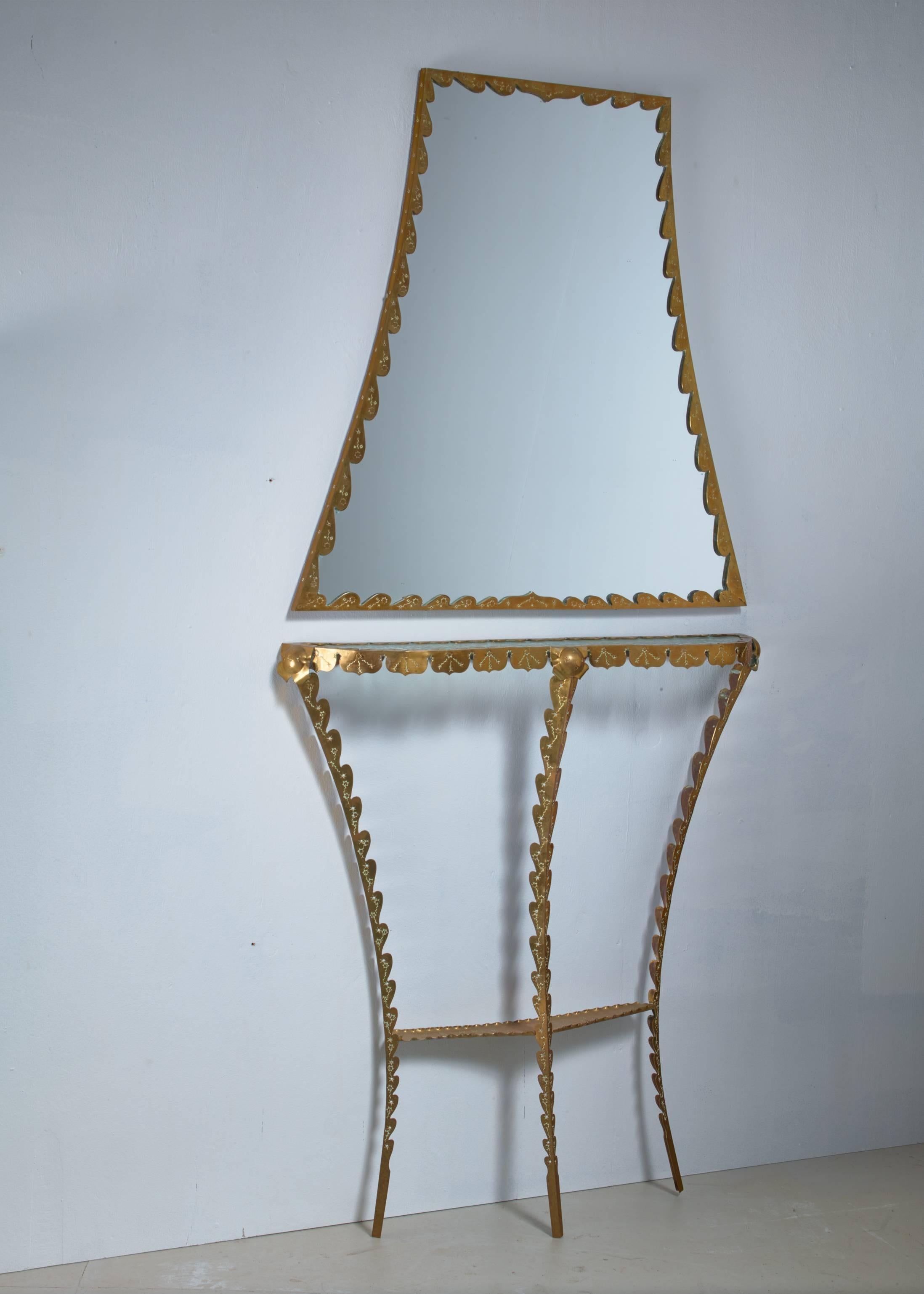A decorated brass console table with a glass top and standing on three thin legs by brass Art Nouveau console table with wall mirror. It has a matching trapeziod wall mirror. 

Very elegant and rich hall way set.

The mirror is 86 cm (34 inch) high