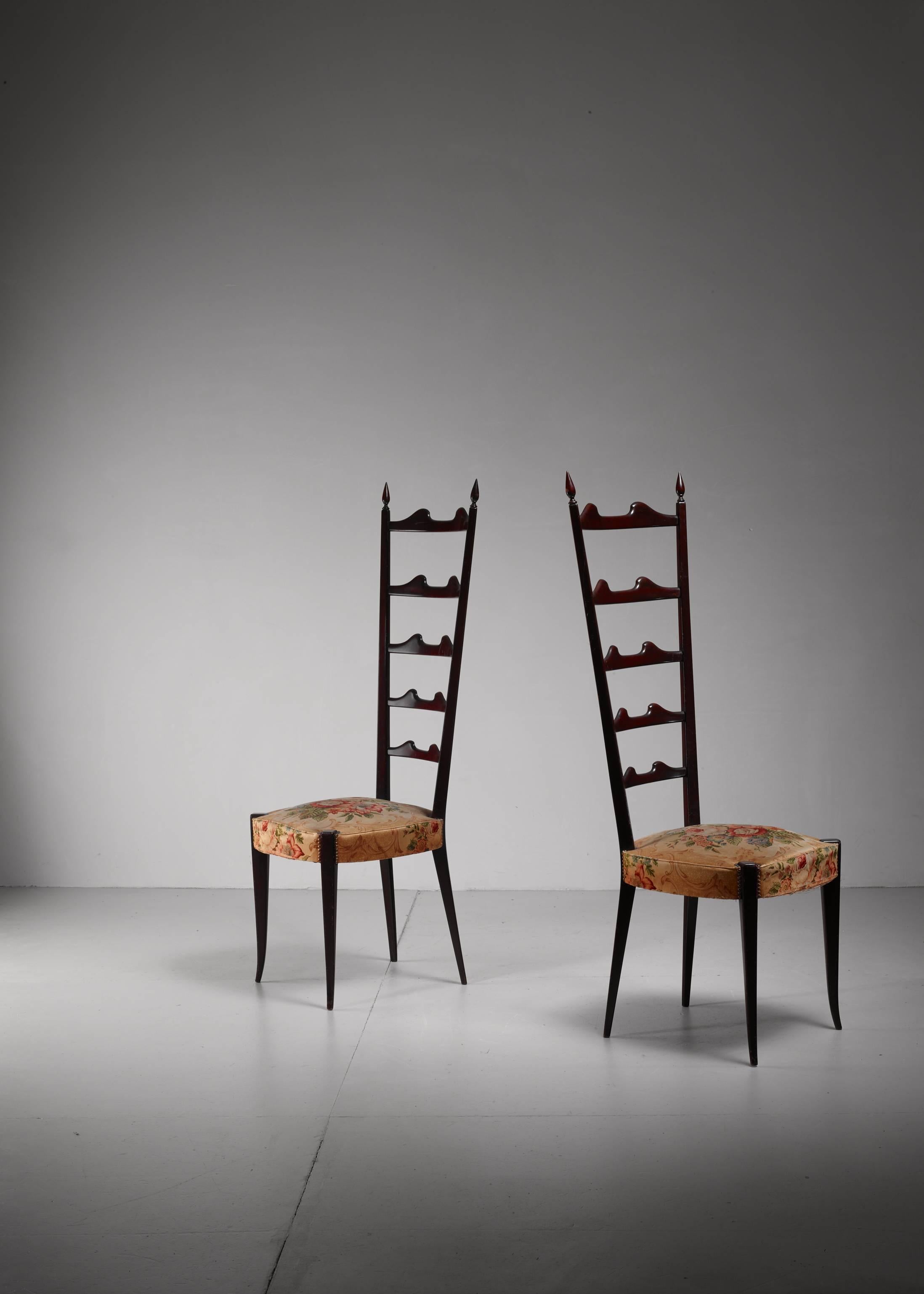 A pair of Chiavari chairs of ebonized mahogany with a high backrest, attributed to Paolo Buffa for Marelli and Colico. The chairs have a floral fabric seating.

The slim and light chairs from Chiavari date back to 1807 and were the inspiration for
