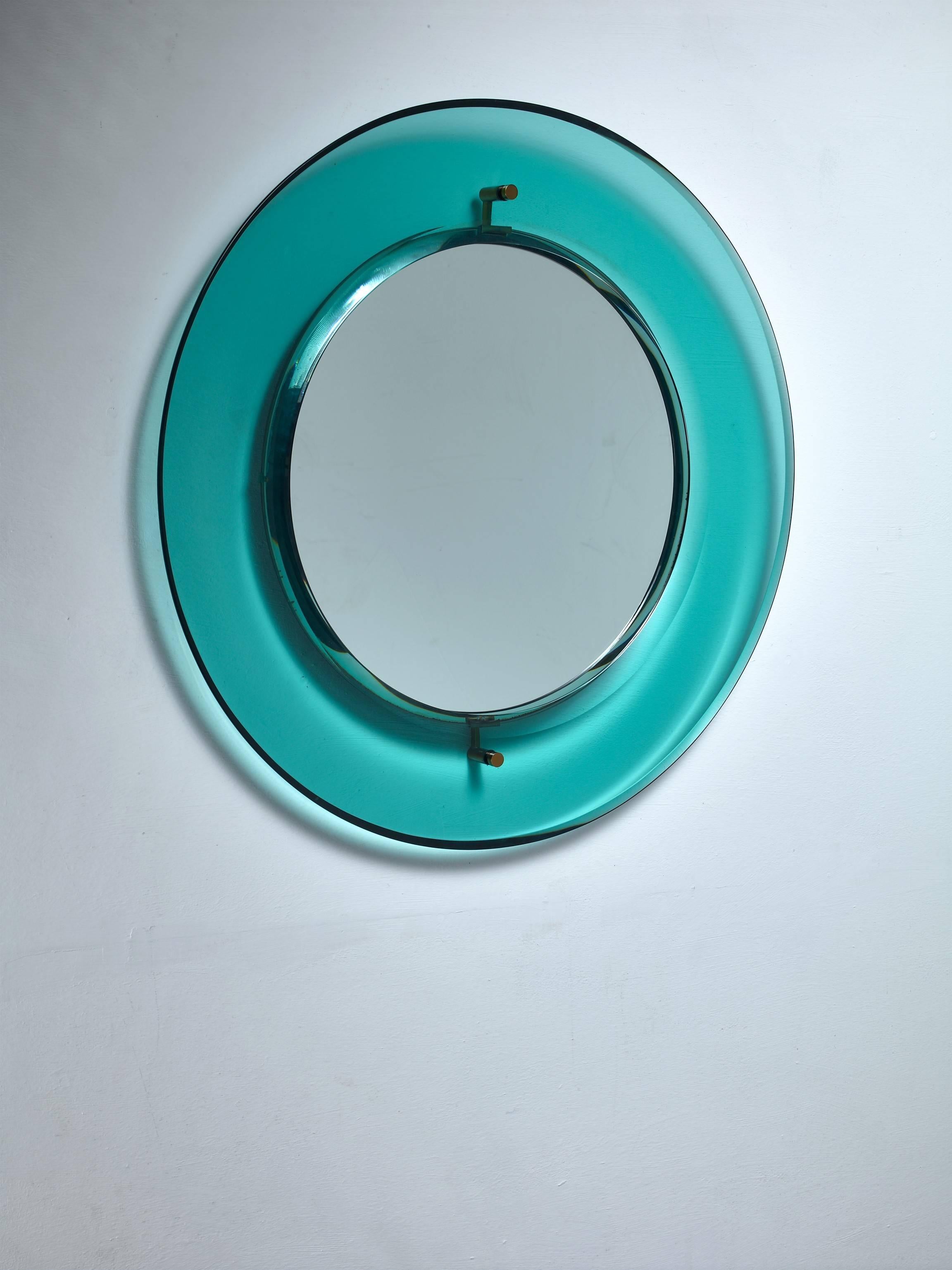 A round glass mirror by Luigi Fontana for Fontanit. The mirror is made of a concave, green glass frame with the mirror in the centre.
Labeled by Luigi Fontana/Fontanit and in an excellent condition.