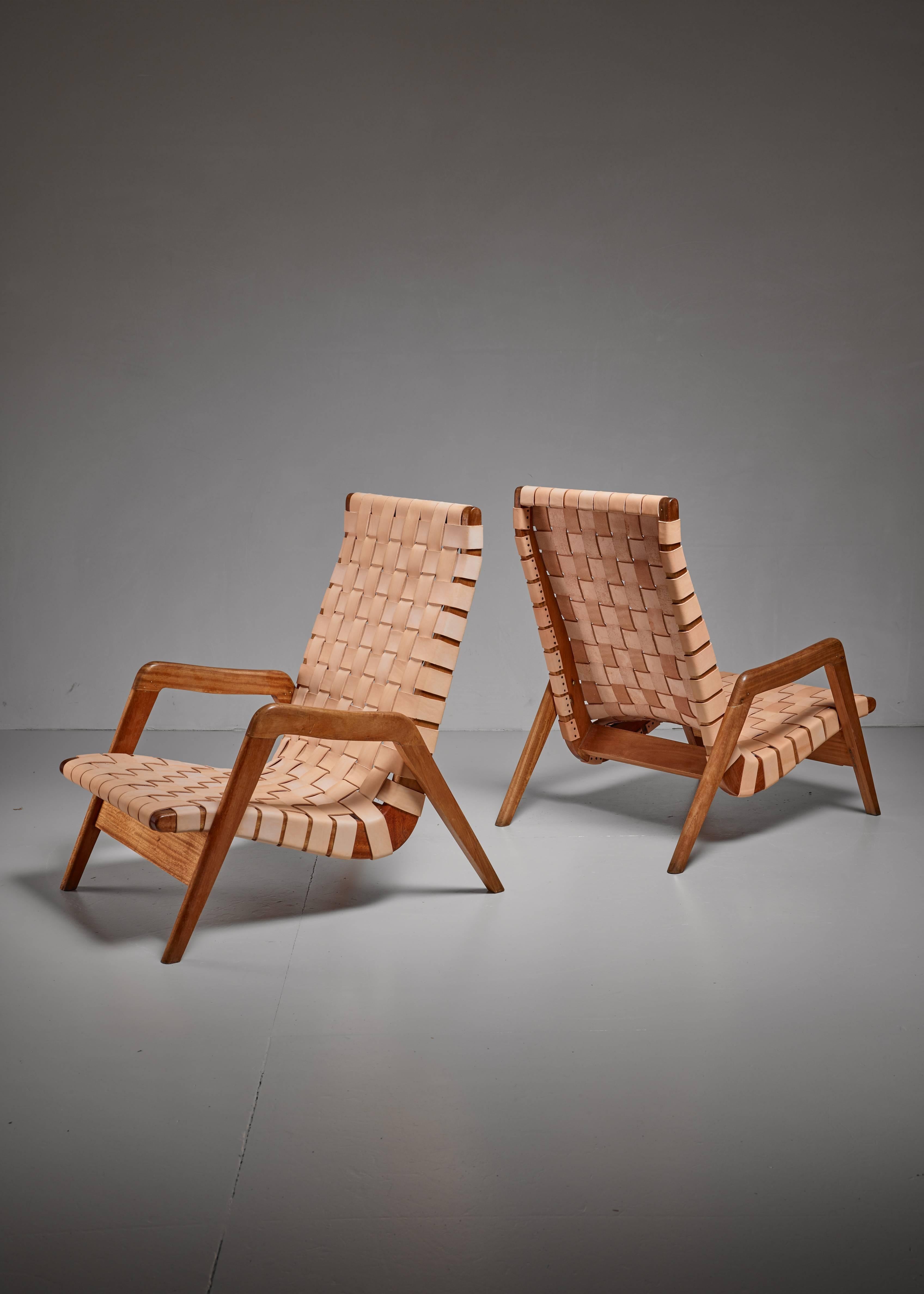 A pair of Mexican iroko lounge chairs, in the manner of Michael van Beuren, with a natural leather webbing. This natural leather will gain a beautiful patina over time.
The chairs have been professionally reupholstered in our in-house atelier.
