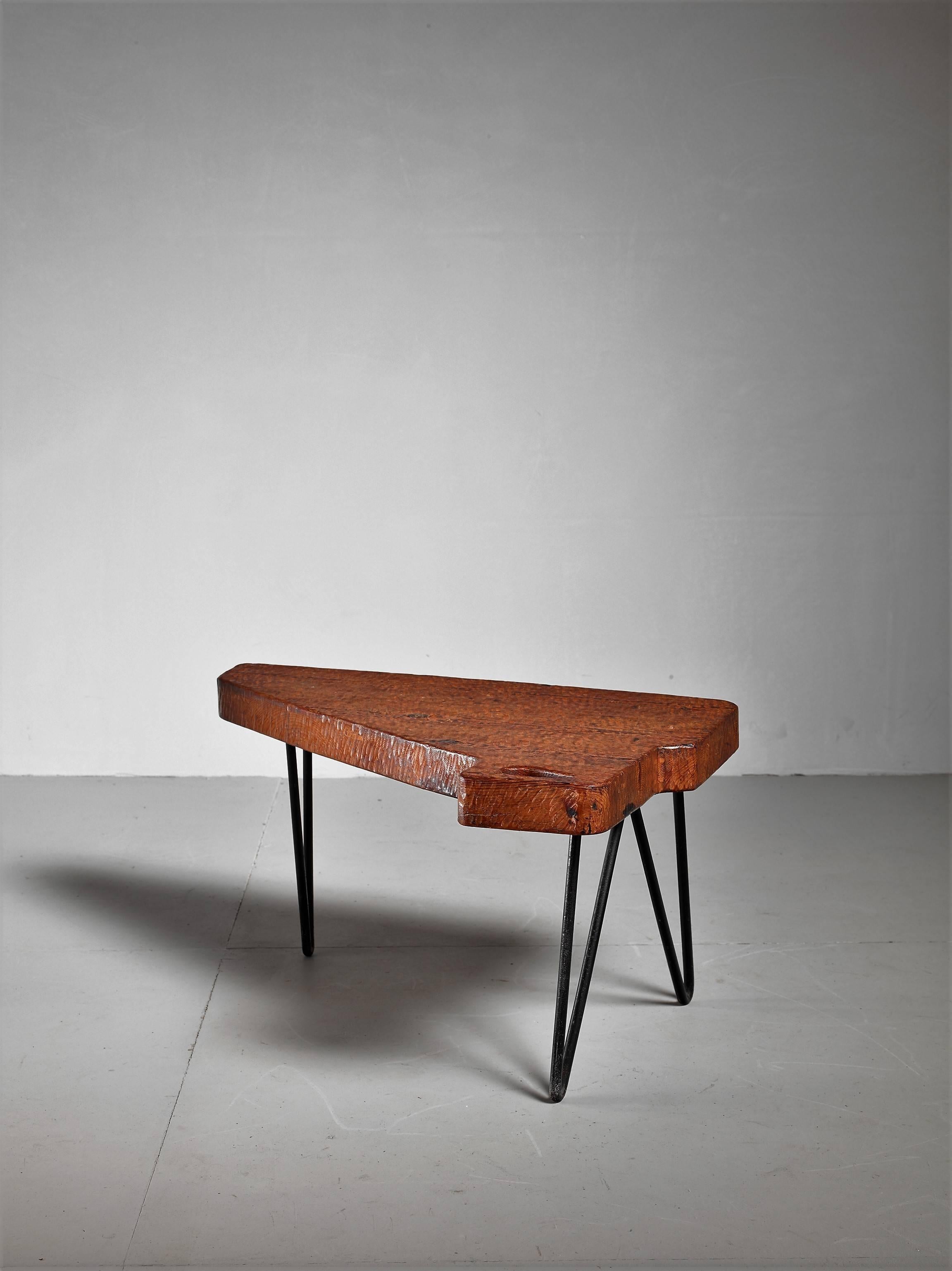 A free-form Mid-Century, Campagne style coffee table from France. The table is made of an iron frame with a thick stained pine top with an opening.

