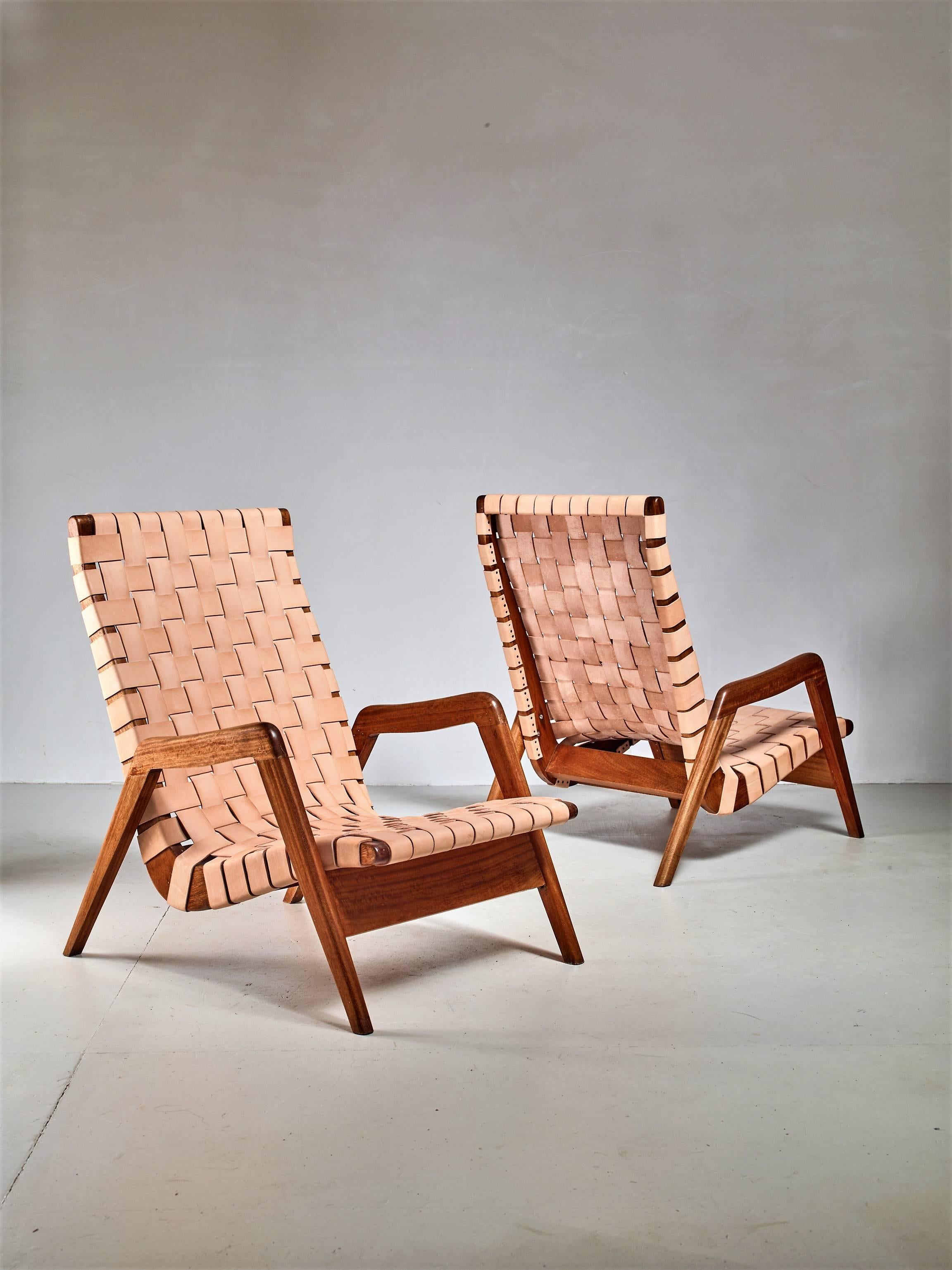 A pair of Mexican iroko lounge chairs, in the manner of Michael van Beuren, with a natural leather webbing. This natural leather will gain a beautiful patina over time,
The chairs have been professionally reupholstered in our in-house atelier. We