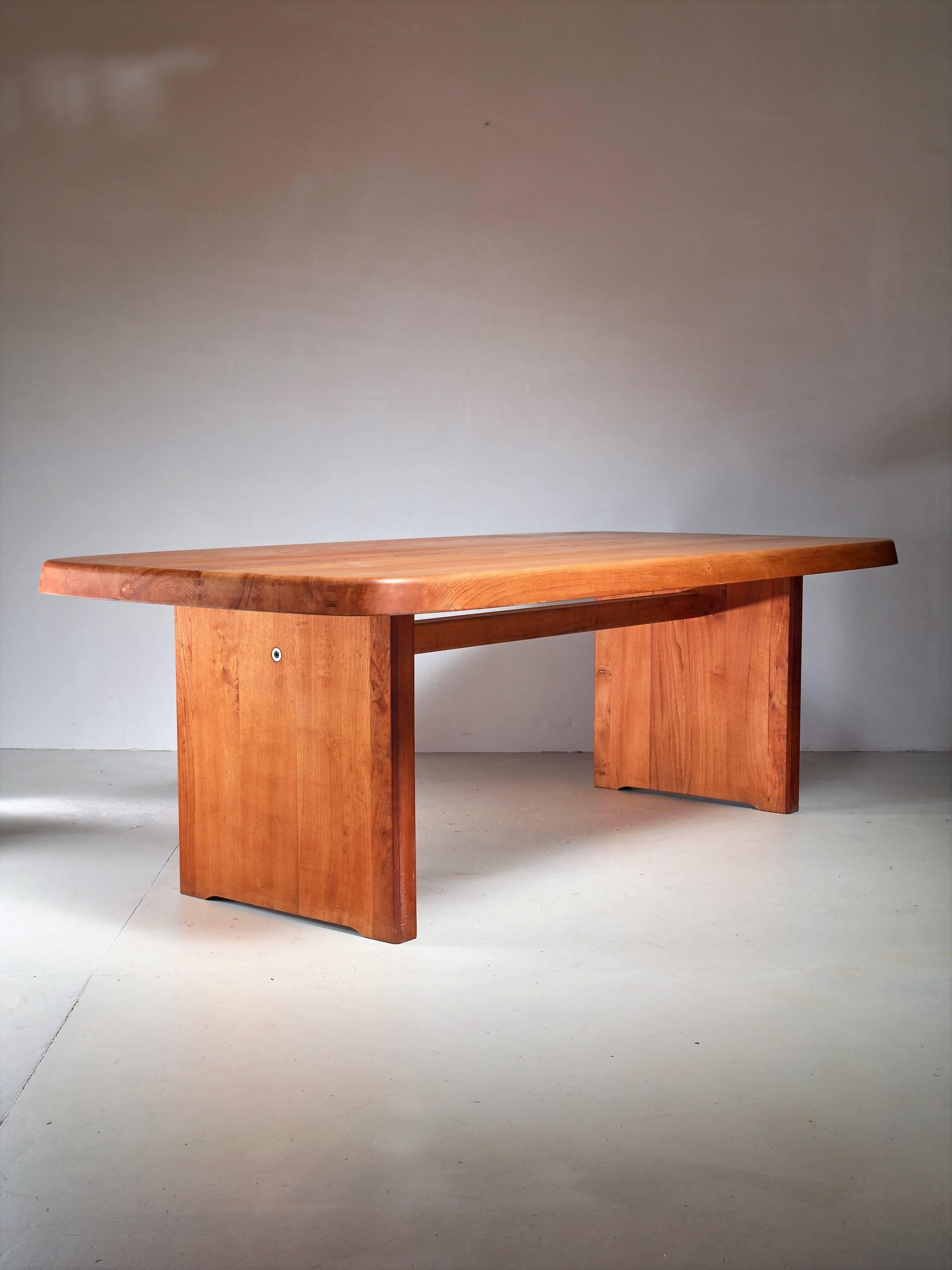 A customized version of Pierre Chapo's T20 dinner table in elm from the 1960s. This large table is suitable for ten chairs and has a solid, 8 cm thick, top. The table is a bit shorter yet wider than the standard model and, contrary to the normal