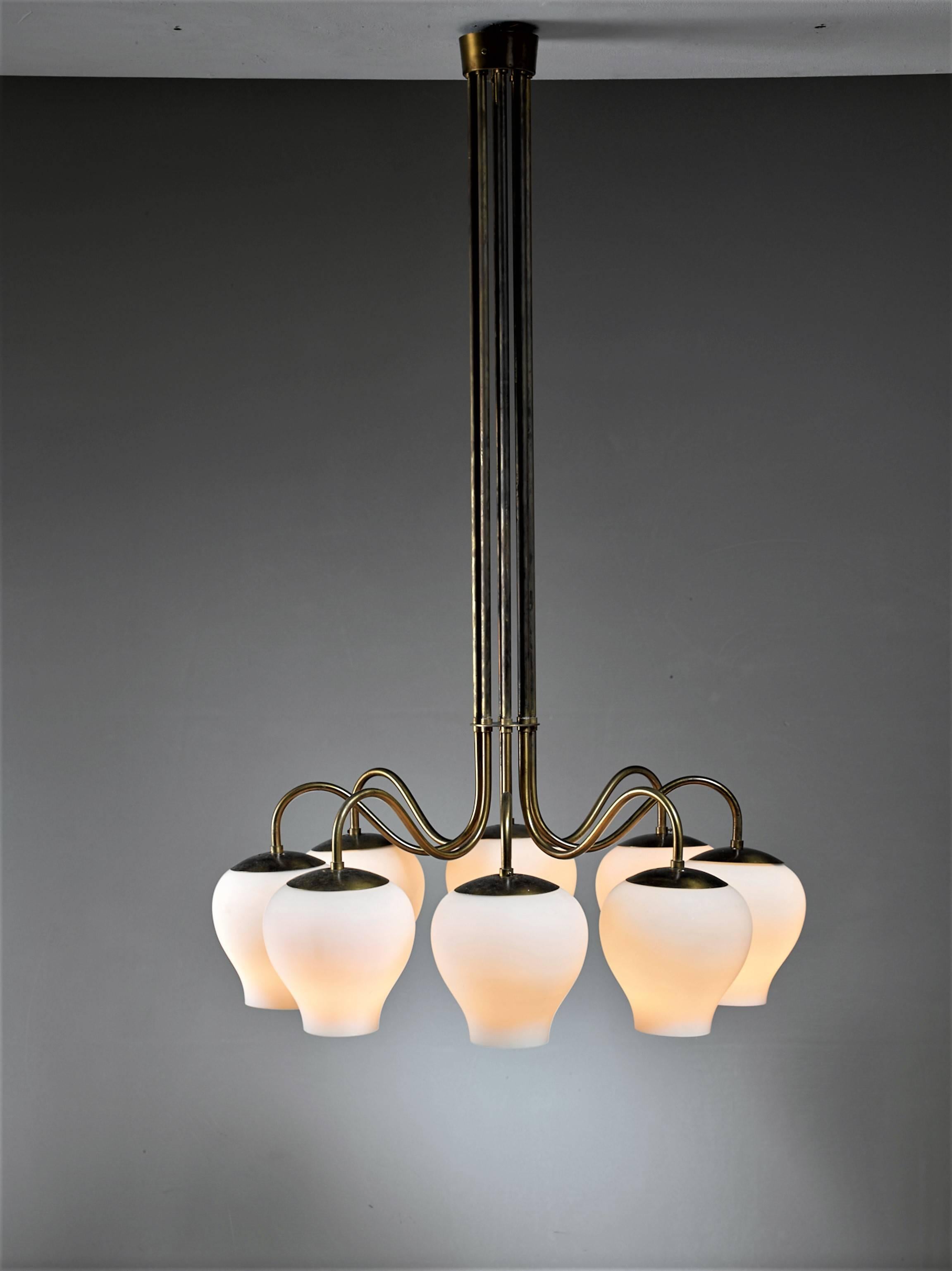 A rare pair 1940s 'Gatling' chandeliers by ASEA Belysning, Sweden. The brass stems form a bundle a the top and curve out at the bottom to hold eight opaline glass shades.
