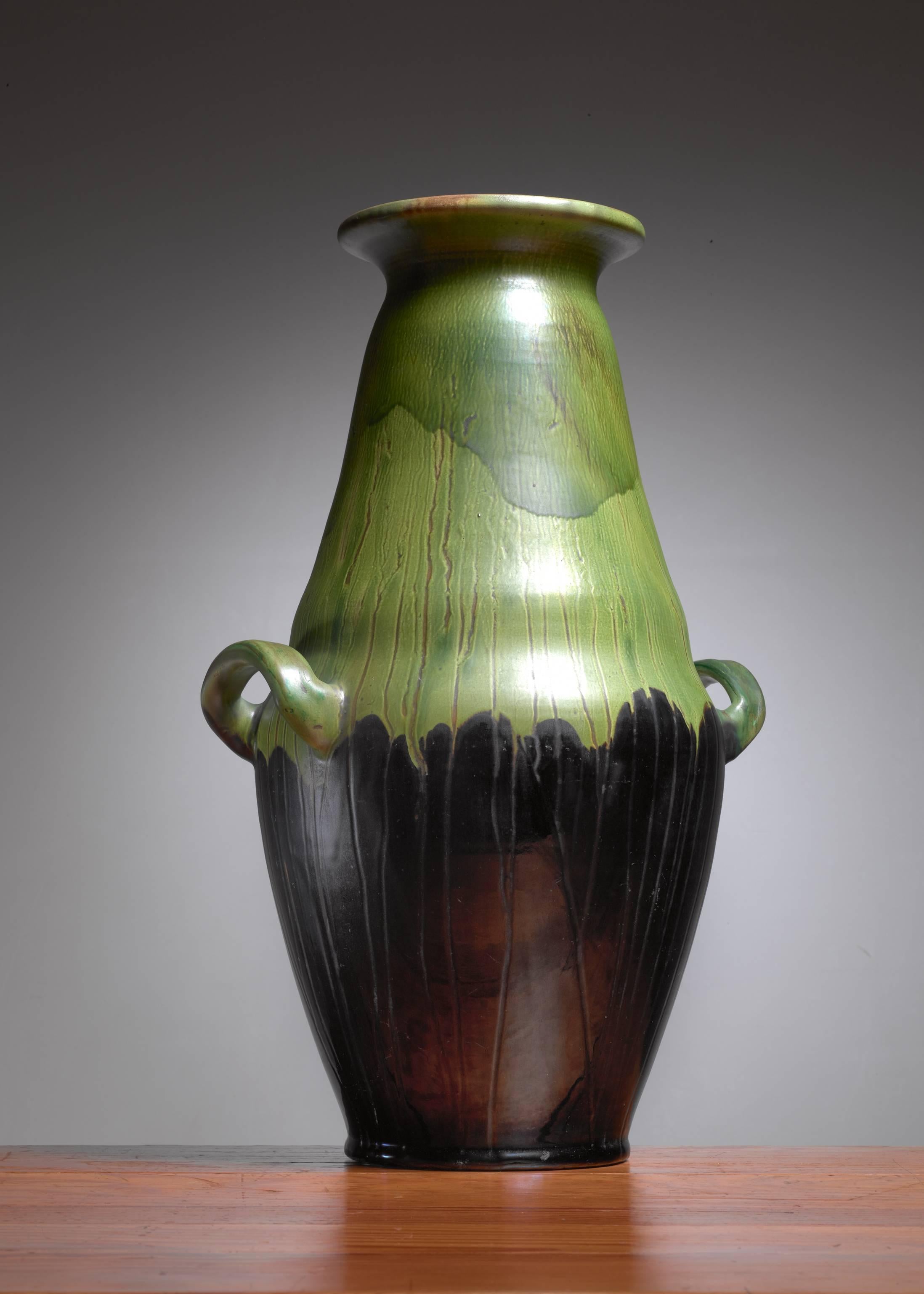 A large ceramic floor vase by Kähler, with a black and green glazing and two ears.