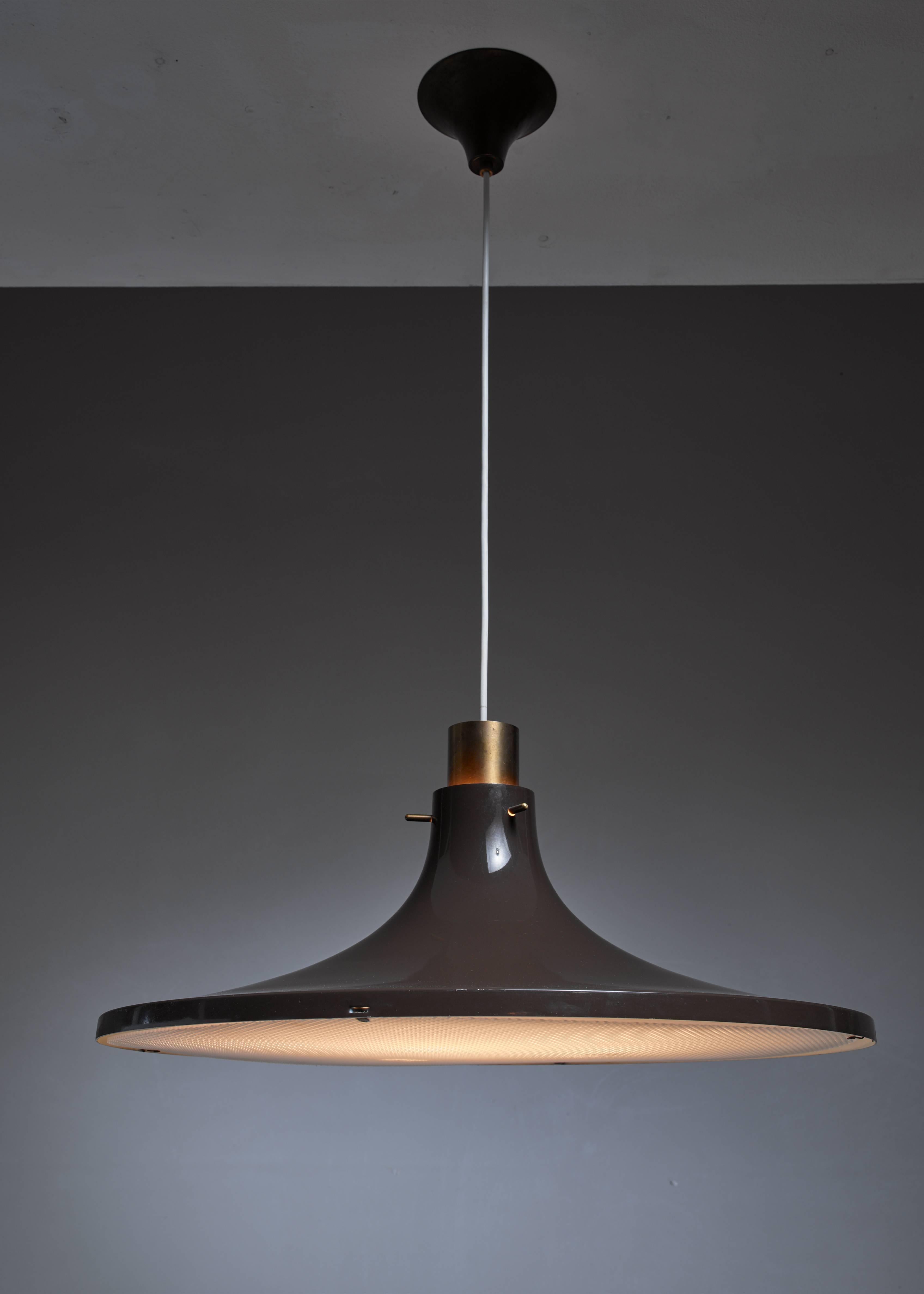 A pendant lamp by Hans-Agne Jakobsson. The lamp is made of brown lacquered metal. It has a brass element on top and a plastic diffuser underneath.
Labeled by Hans-Agne Jakobsson, Markaryd.