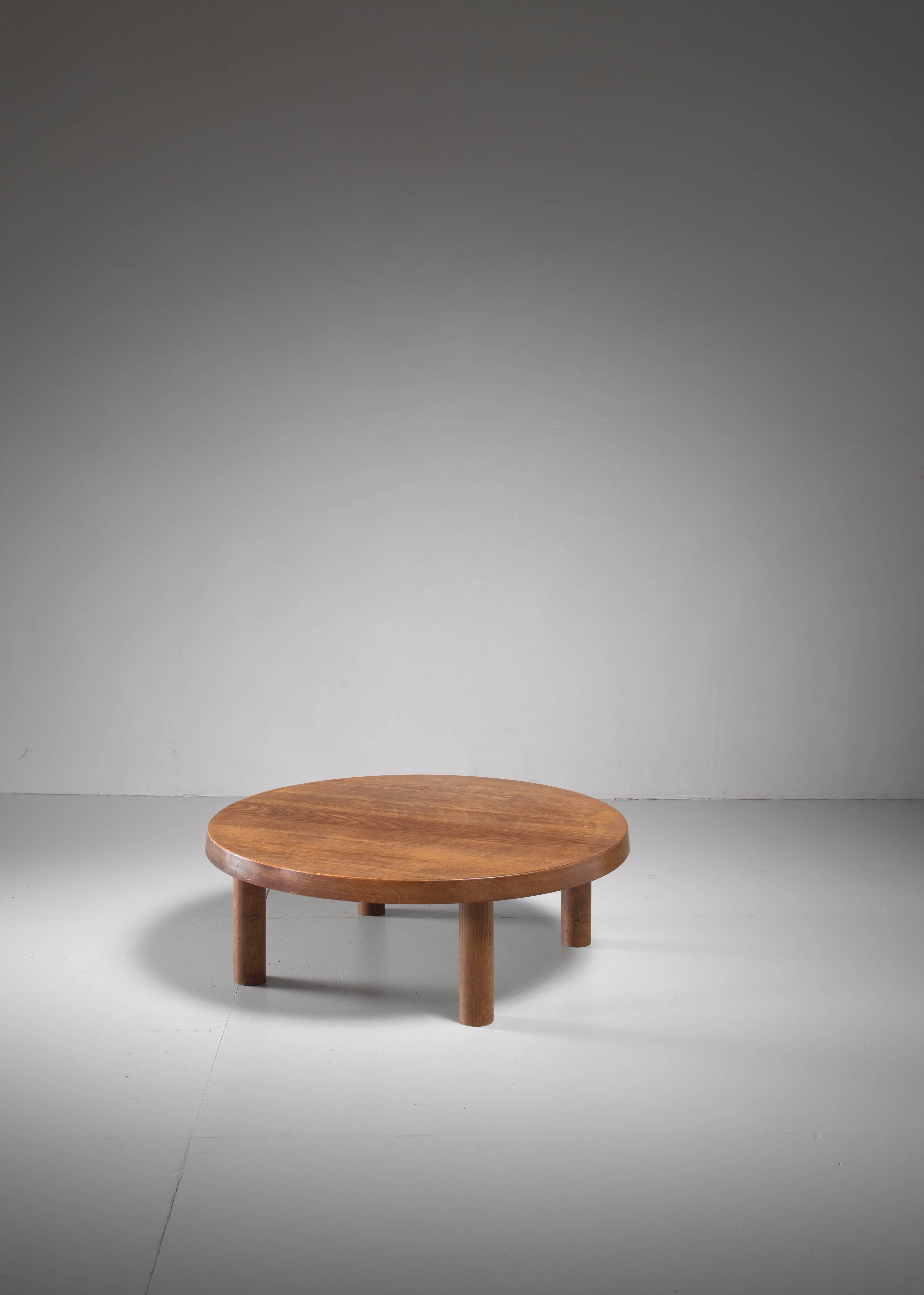 A large (95 cm diameter), low and round model T02 coffee table in oak by Pierre Chap. The table has a 5 cm thick top.

This piece is offered to you by Bloomberry, Amsterdam.
