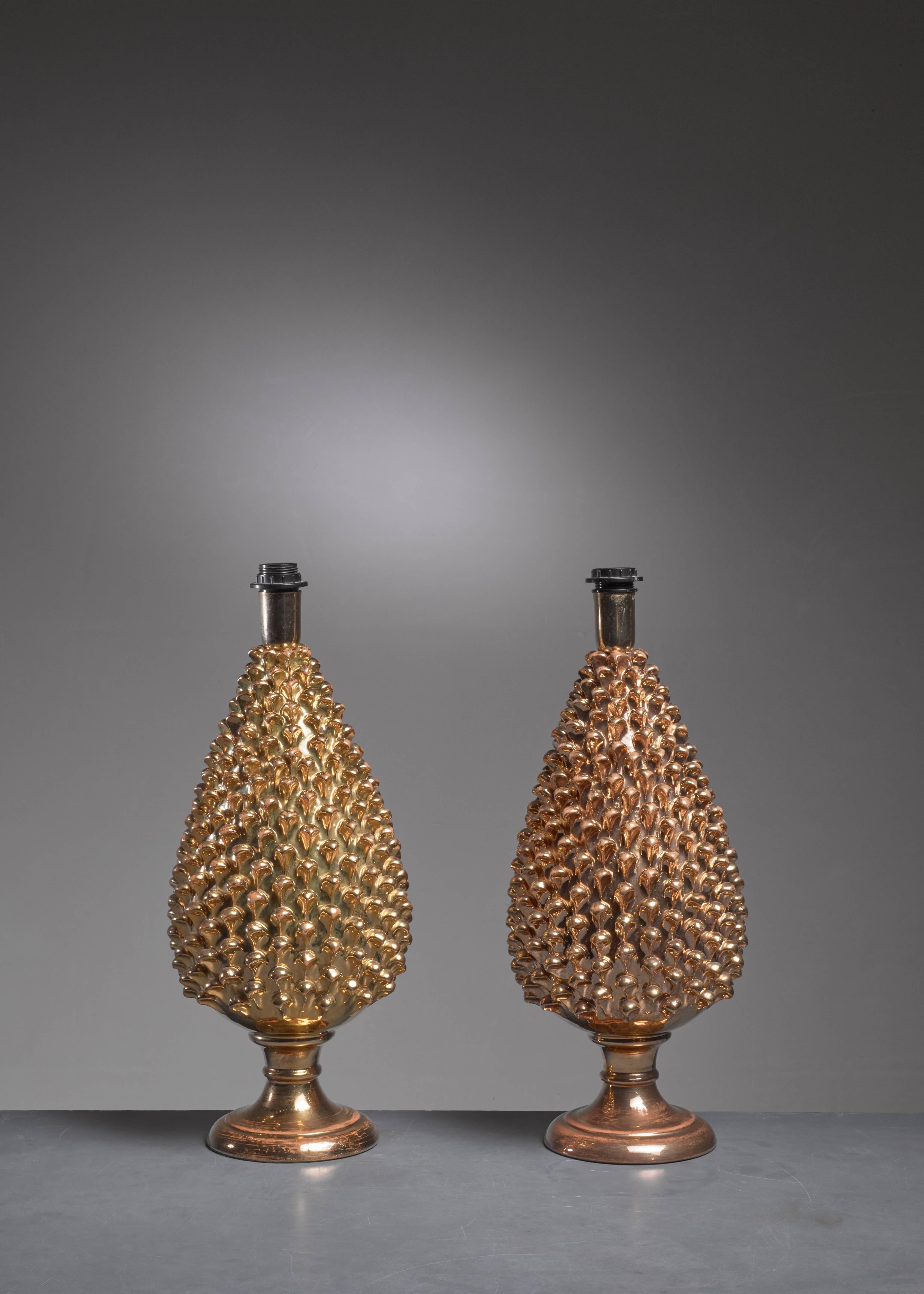 A pair of organically shaped Mangani table lamps made of gold painted glass.
