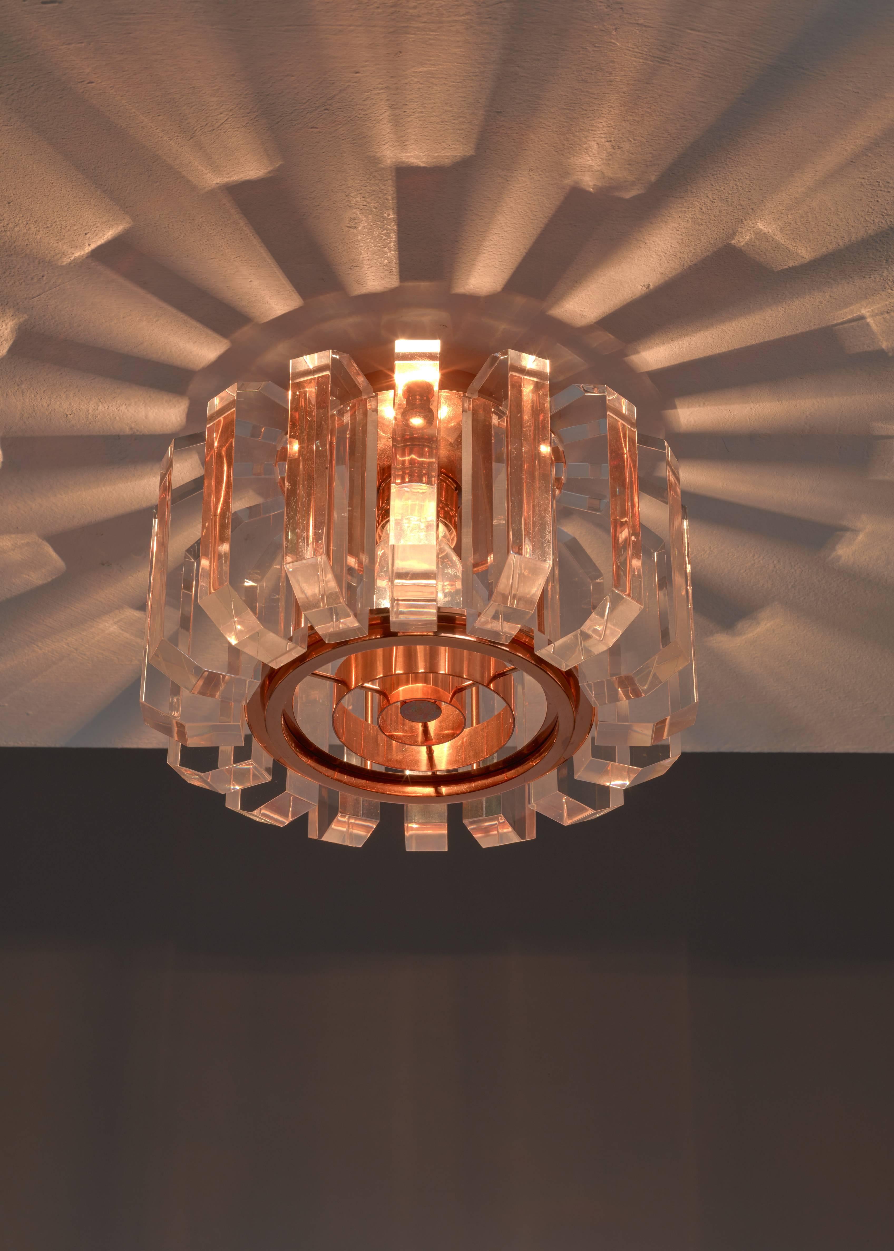 A very rare flush mount ceiling lamp made of 18 thick plexiglass elements around a copper frame with a copper grid. The lamp is produced by French Leuchten, also known for the production of the lighting by Rudolf Schwarz.

We have three of these