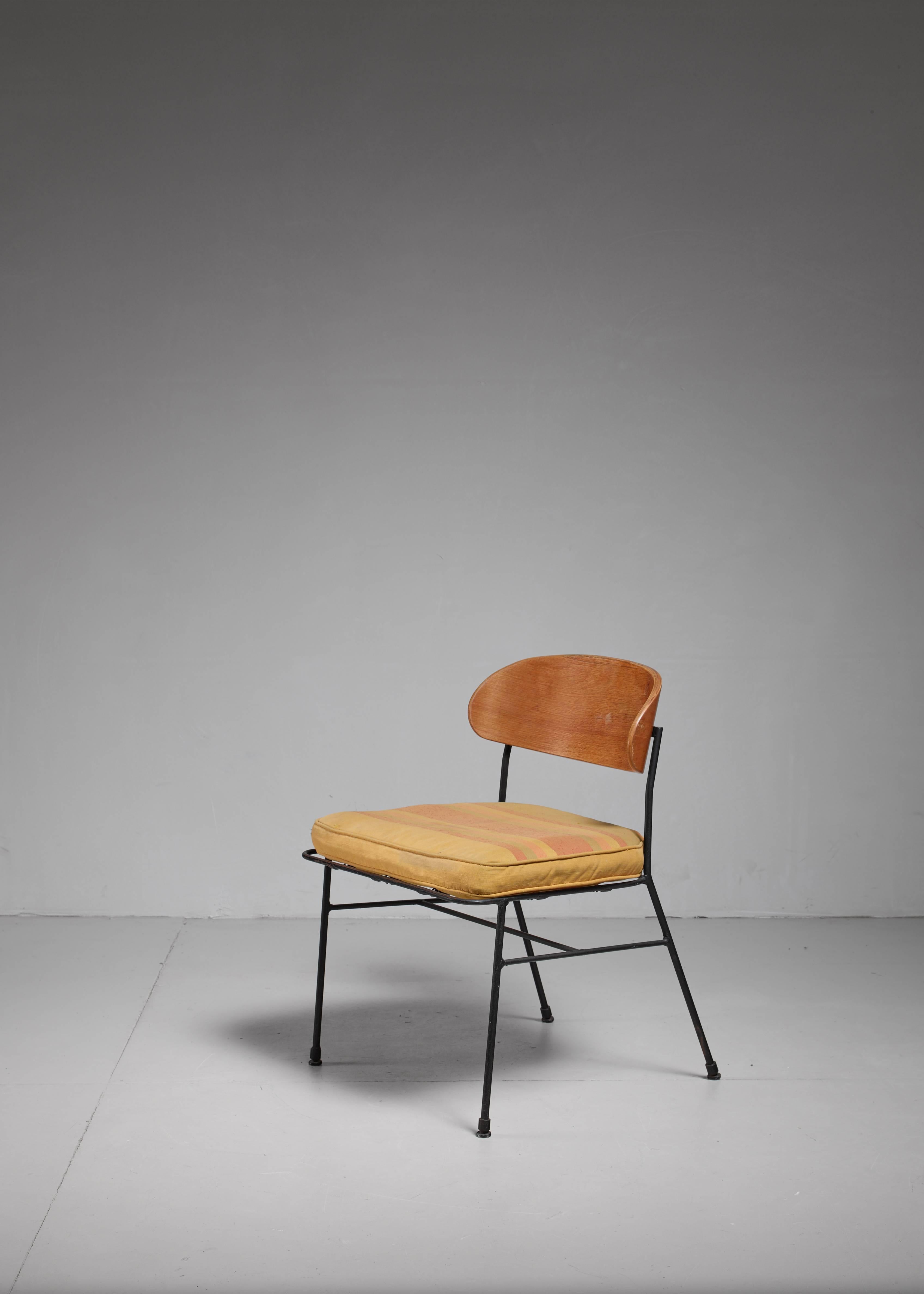 A 1950s chair, made of a black lacquered iron frame with a bentwood seating and backrest. The chair comes with a yellow/orange cushion that has been professionally restored. Paul Laszlo design for Pacific Iron Products (L.A.) model No. 2100 from the