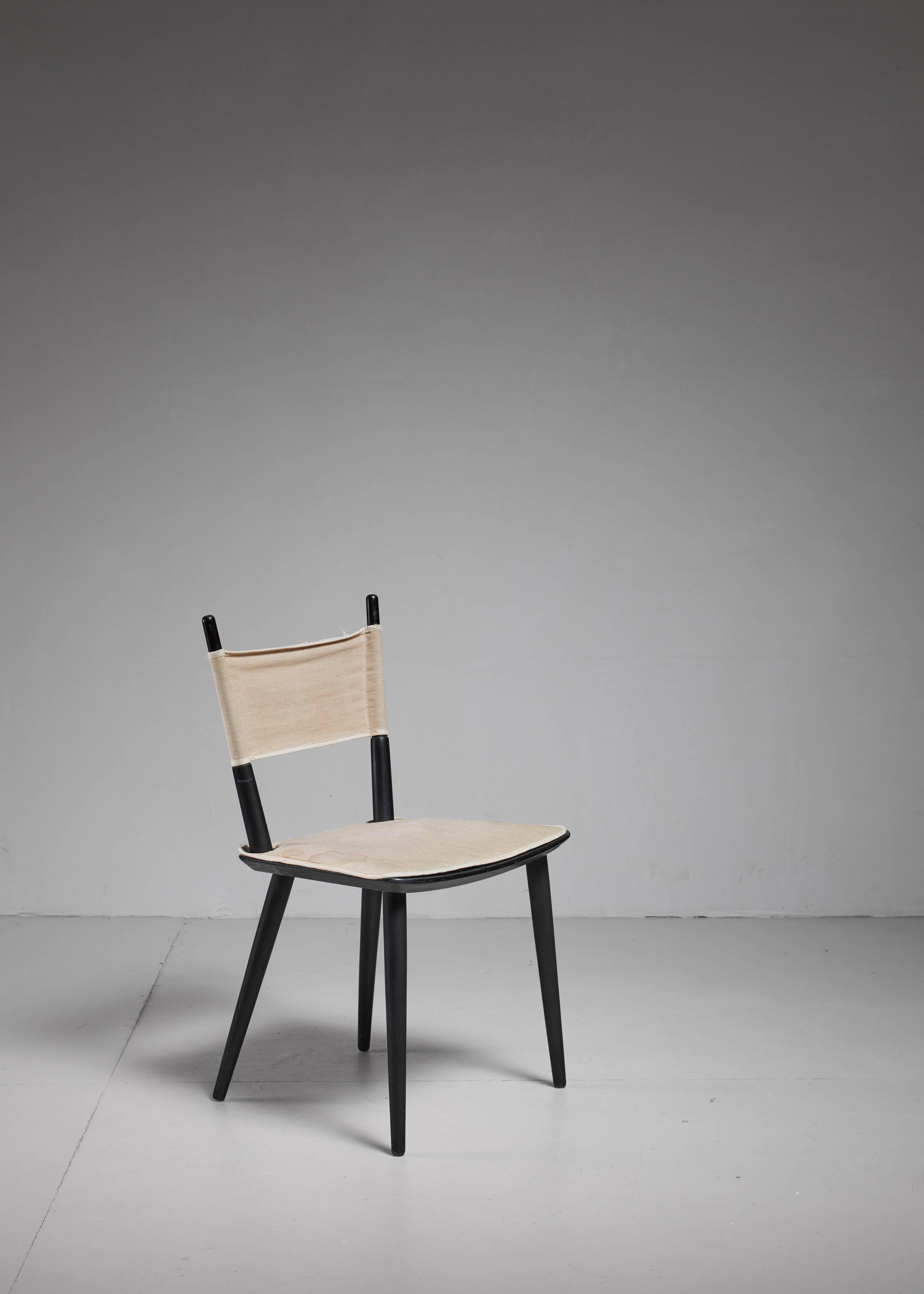 A rare and original model J108 side chair, designed in the 1950s by Jorgen Baekmark for FDB Møbler. The chair is made of a black lacquered beech frame with a canvas seat pad and backrest. This lightweight chair can easily be disassembled. The chair