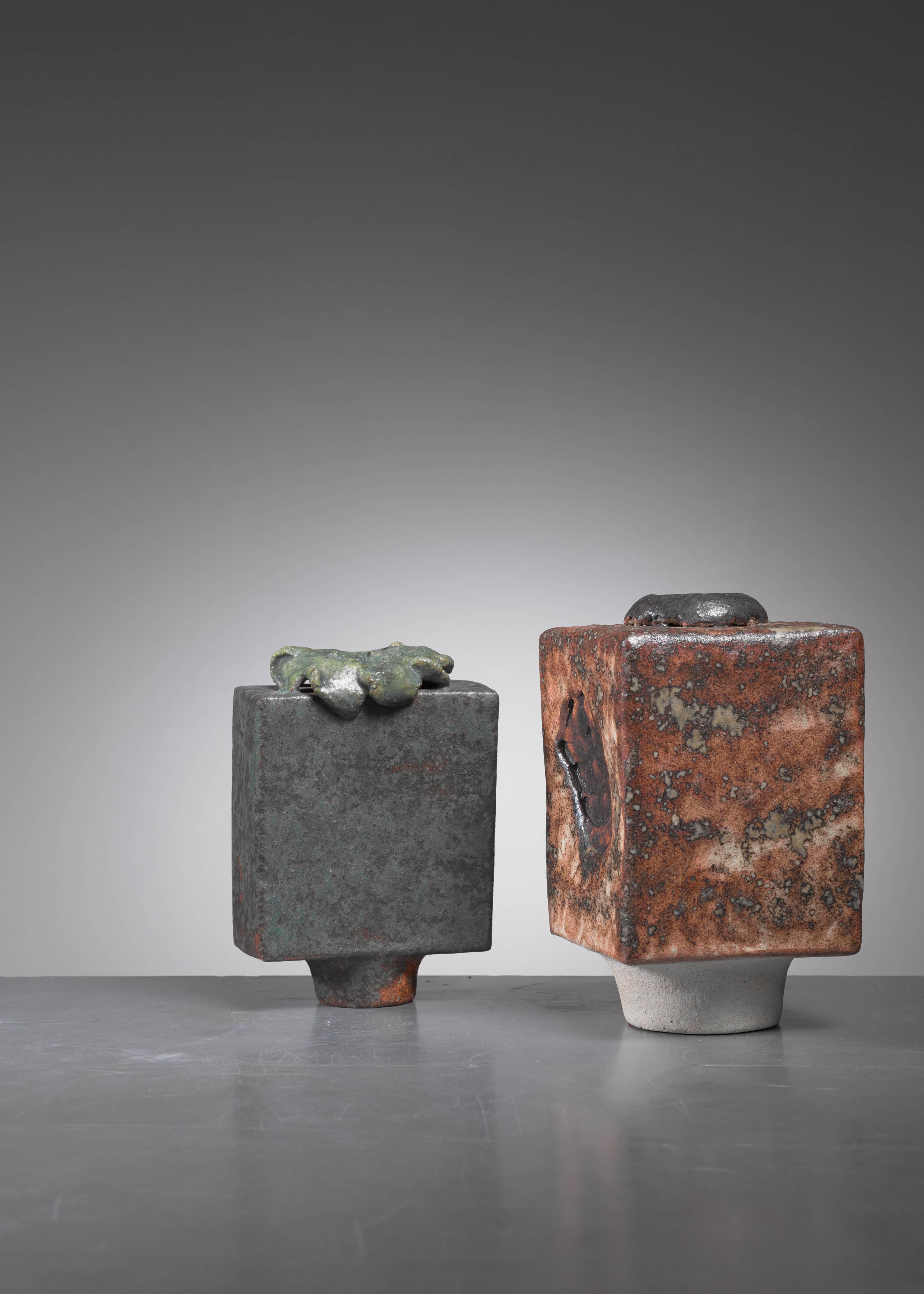 A pair of sculptural ceramic vases by German ceramist Lotte Reimers, 1932.

The measurements stated are of the anthracite and green vase. The brown piece is 9 by 9 cm and 16 cm high. Signed by Reimers with the years of production (1973 and