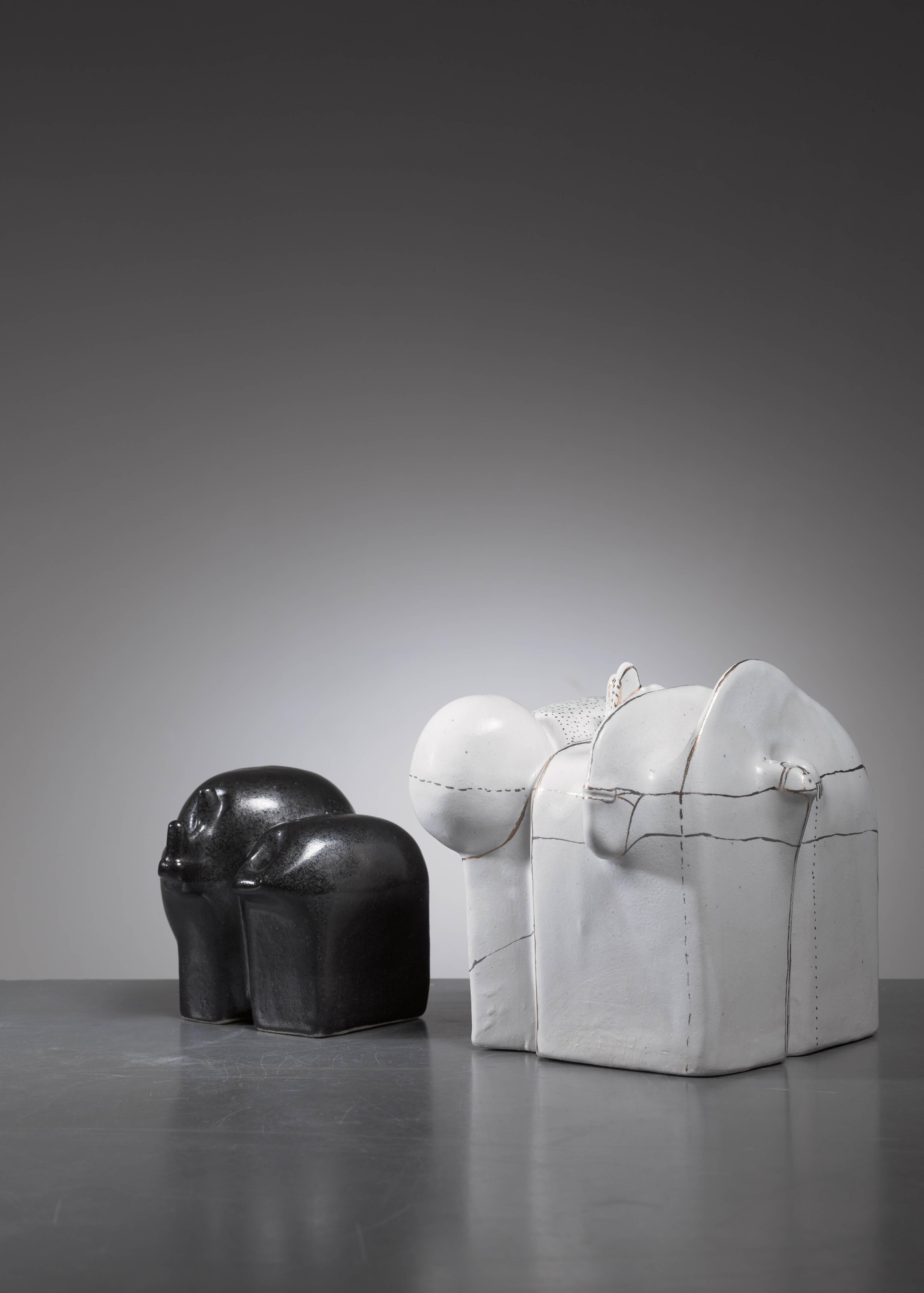 A pair of highly sculptural ceramic vases or objects by German ceramist Antje Schimpfle.

The measurements stated are of the black vase with five openings. The white piece with four openings, decorated with gold colored line and dot decorations,
