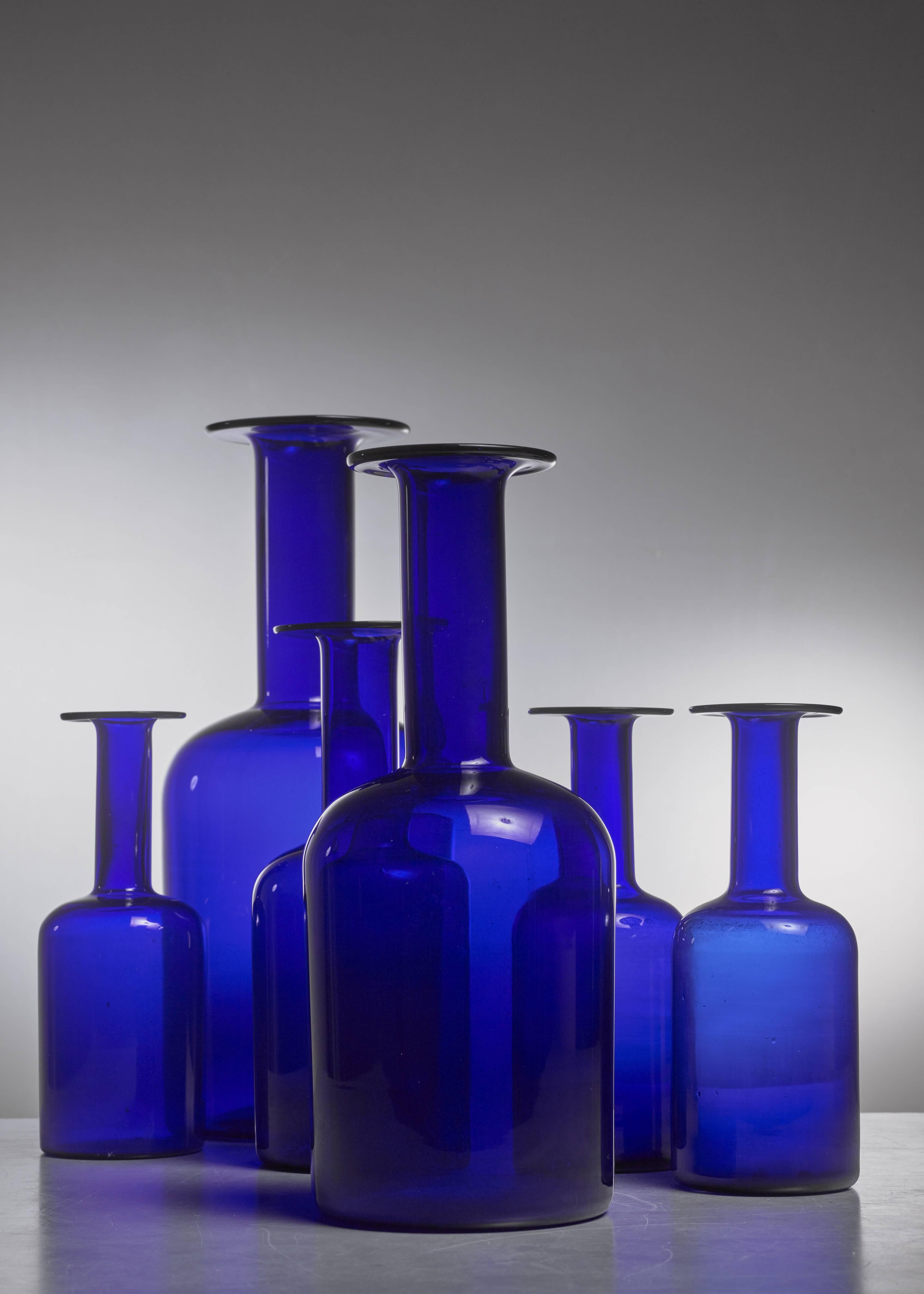 A set of six blue glass Gulvases in varying sizes, designed by Otto Brauer for Danish company Holmegaard. Measure: The smallest vase is 25 cm high with a 9.5 cm diameter. The tallest one is 43.5 cm high with a 17.5 cm diameter.

The middle size vase
