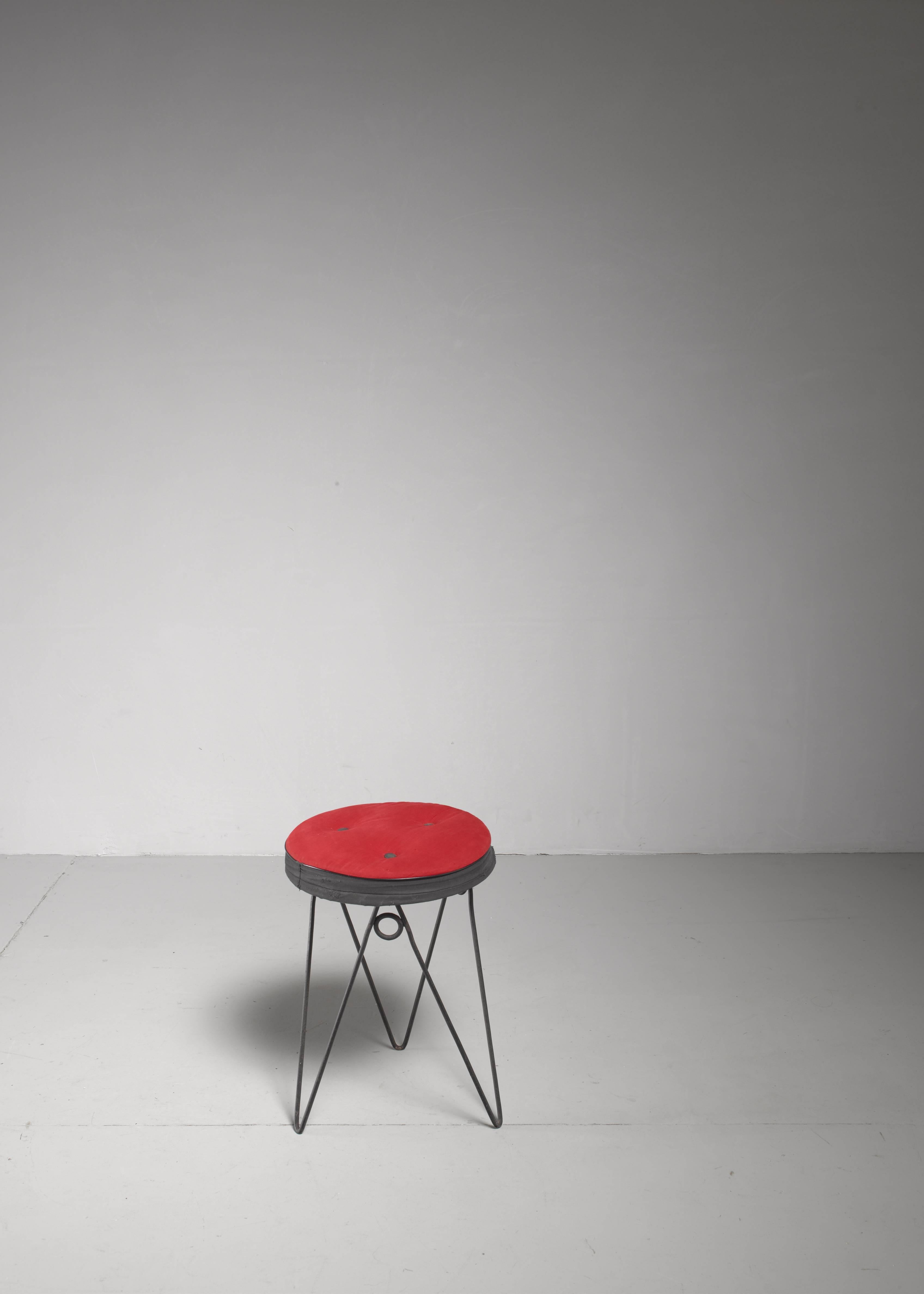 A 1950s French stool. The stool is made of a playful iron hairpin frame with a black and red fabric seat pad. 

The seat pad has been professionally restored, using the original fabric. Only the foam has been replaced.