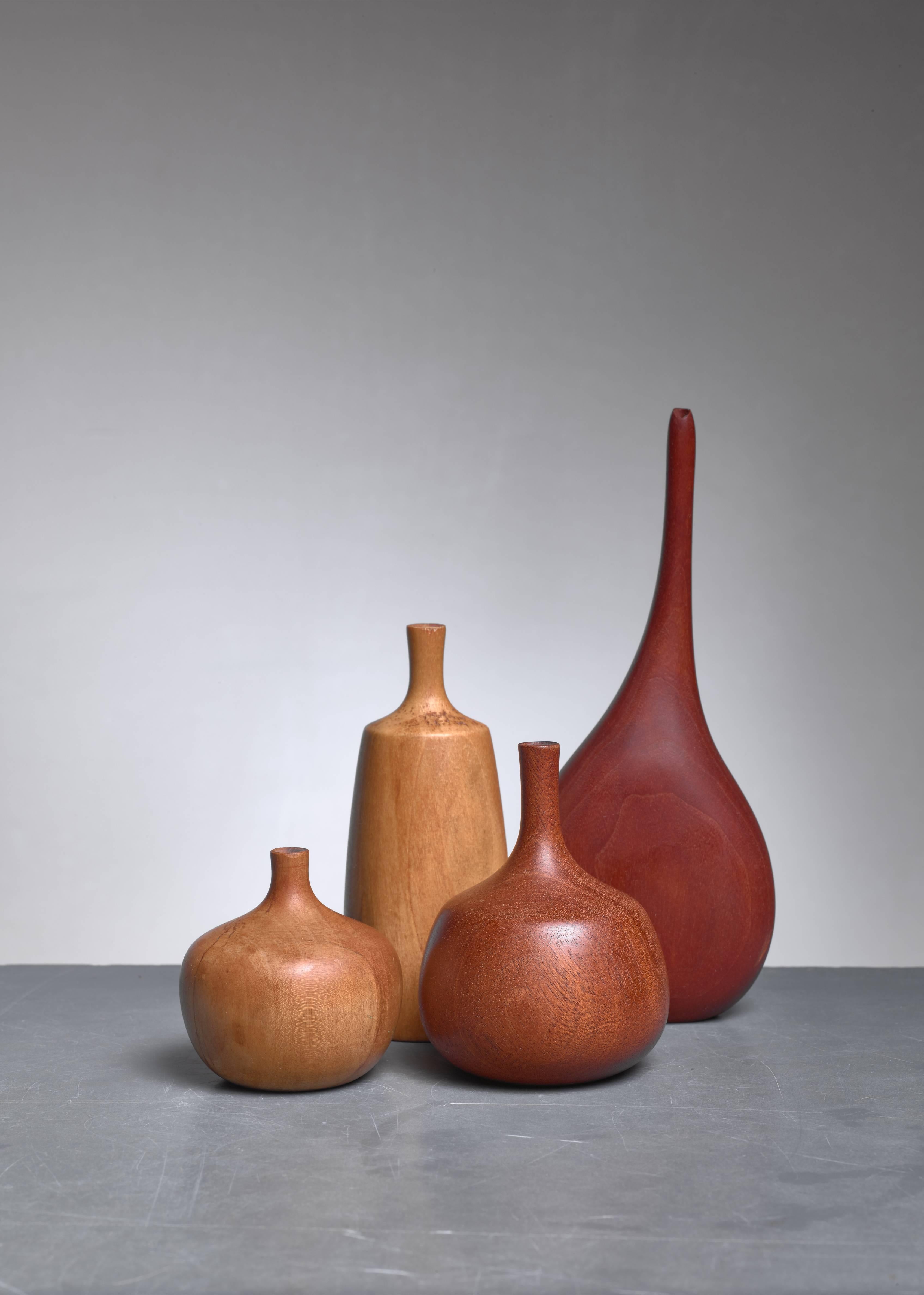 A set of four small vase made of turned wood, three of them by the be known American Craftsman woodturner Rude Osolnik.

The three smaller pieces by Osolnik are made of maple, mahogany and poplar. The largest, walnut, vase is made by an unidentified