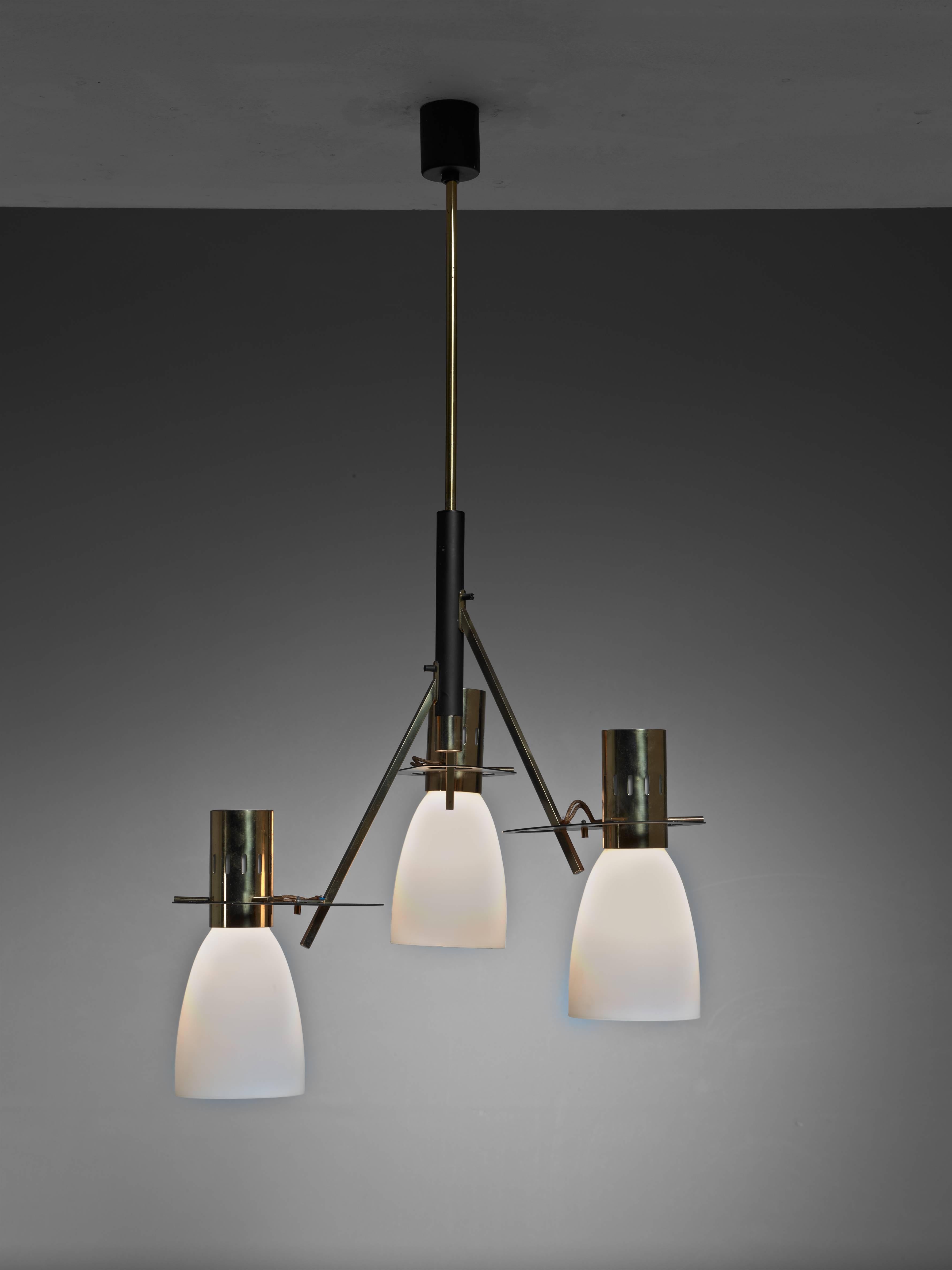 A three-armed midcentury Stilnovo brass pendant with opaline glass shades. The lamp is currently wired to shine downwards, but it can be rewired to position the shades upwards. Total drop can be adjusted to your requirements.