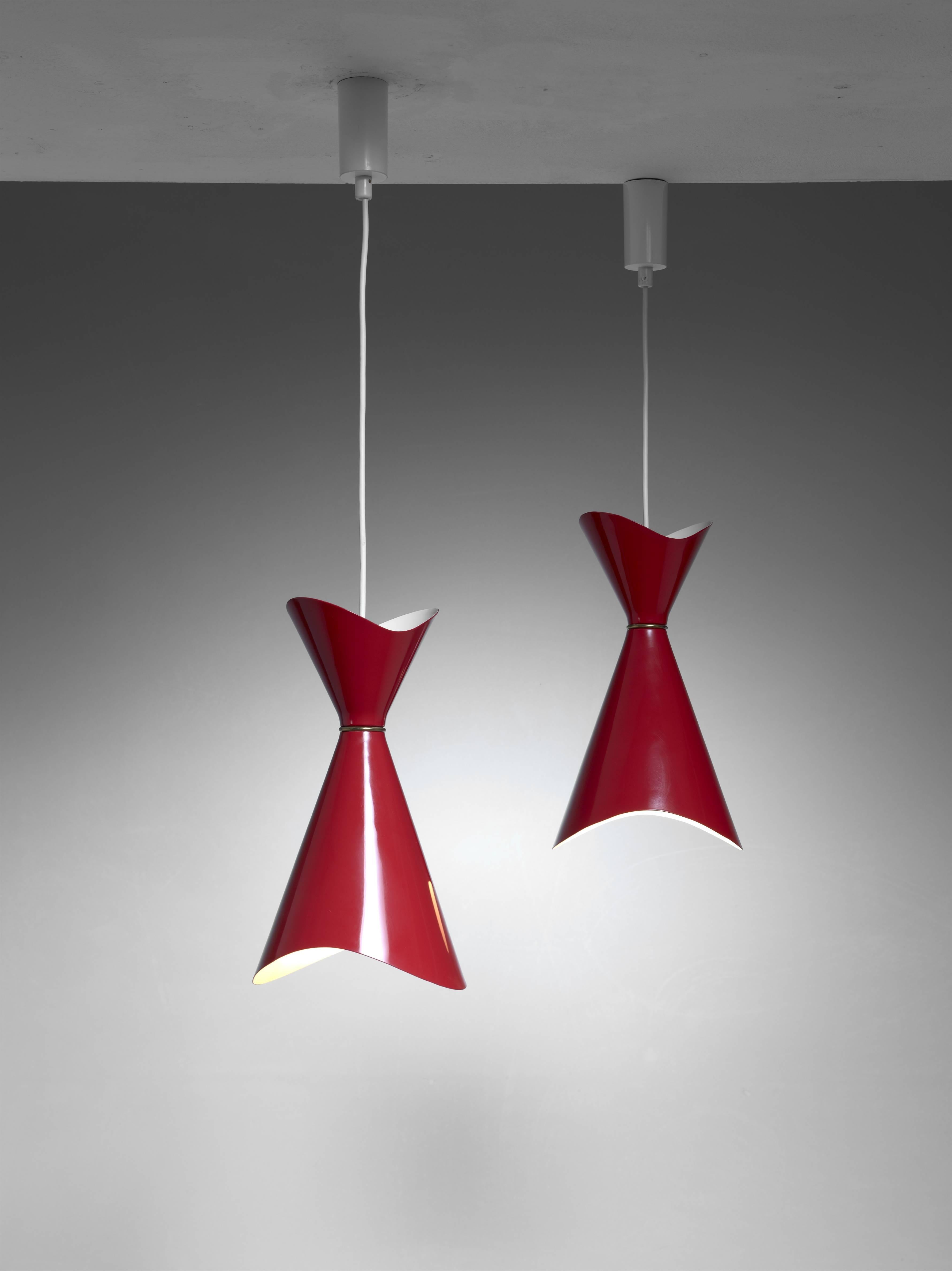 A pair of red metal 'Ninotchka' pendant lamps by Bent Karlby for Lyfa.

Karlby seems to have been inspired by the red hat of Greta Garbo in her title role in the 1939 MGM movie production 'Ninotchka'.

The total drop can be adjusted to your