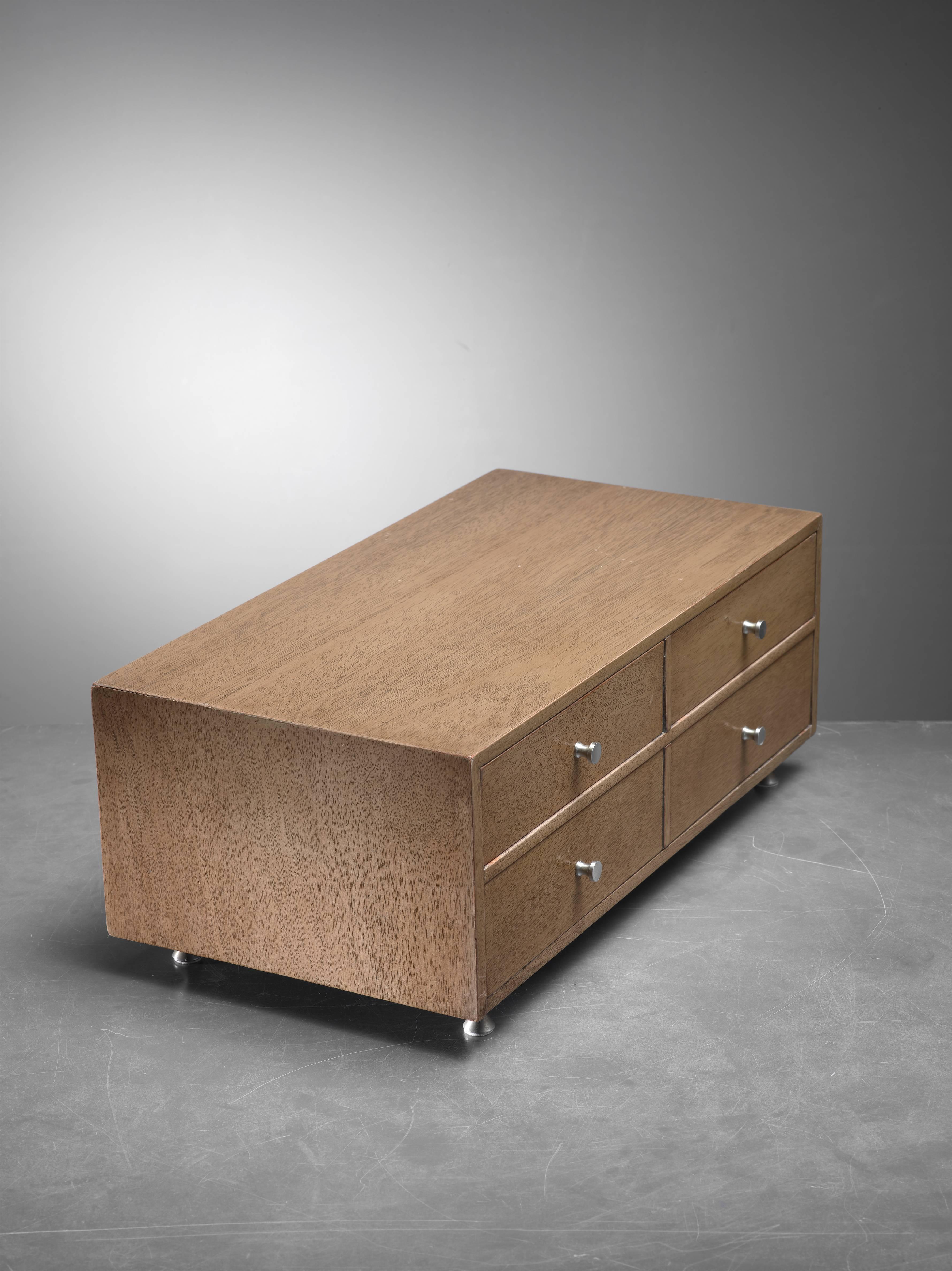 A beautiful midcentury wooden jewelry chest with aluminum pulls, by Arthur Umanoff. Possibly for the Elton Furniture Company. The chest holds four drawers and is in an excellent condition.