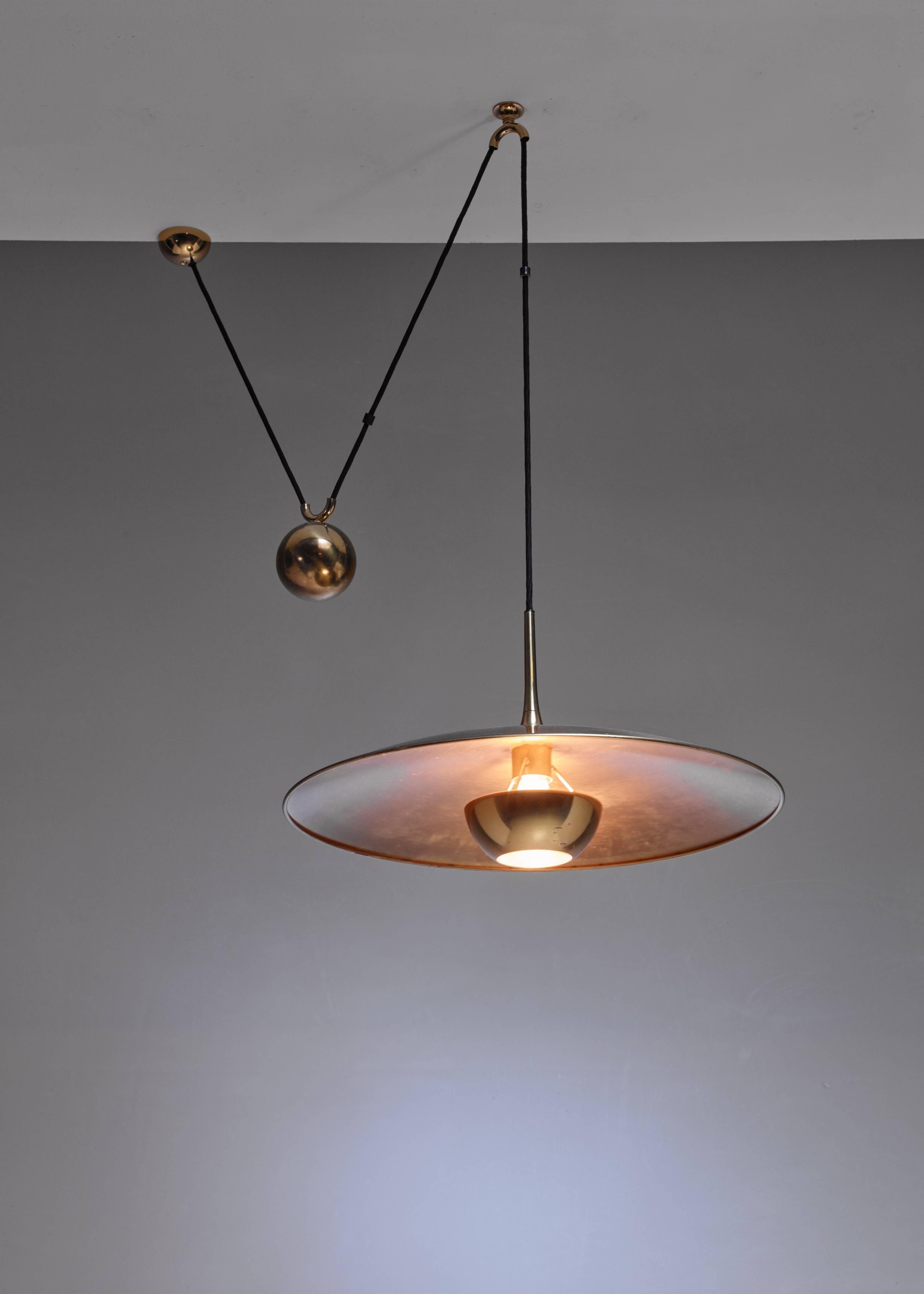 A brass model 'Onos 55' pendant lamp with a heavy brass counterweight, by German designer Florian Schulz.

     