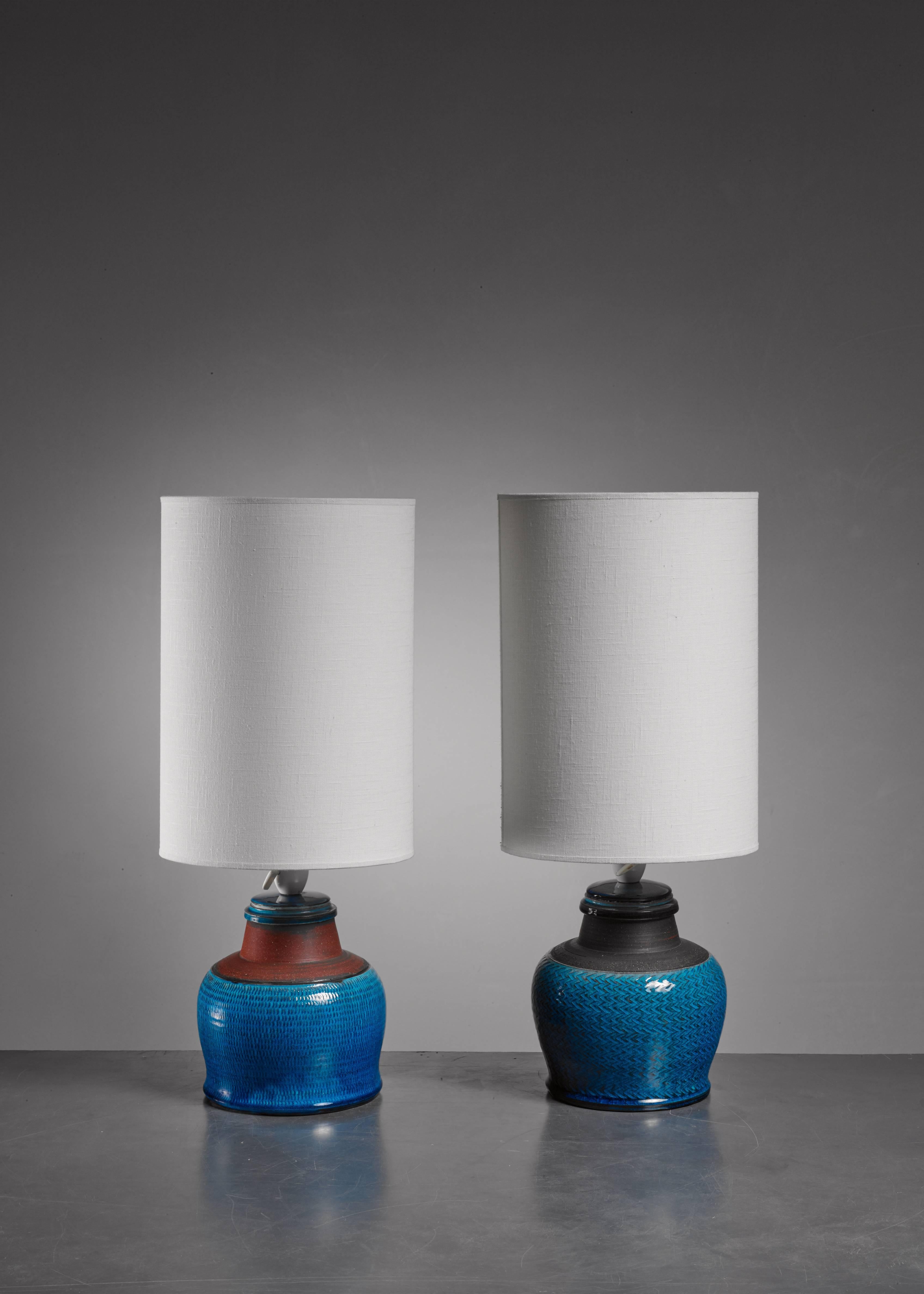 A pair of bulbous, blue and brown ceramic table lamps by Kähler.

The measurements stated are of the lamps without the shade. The lamps are signed by Kahler underneath and in an excellent condition.

 