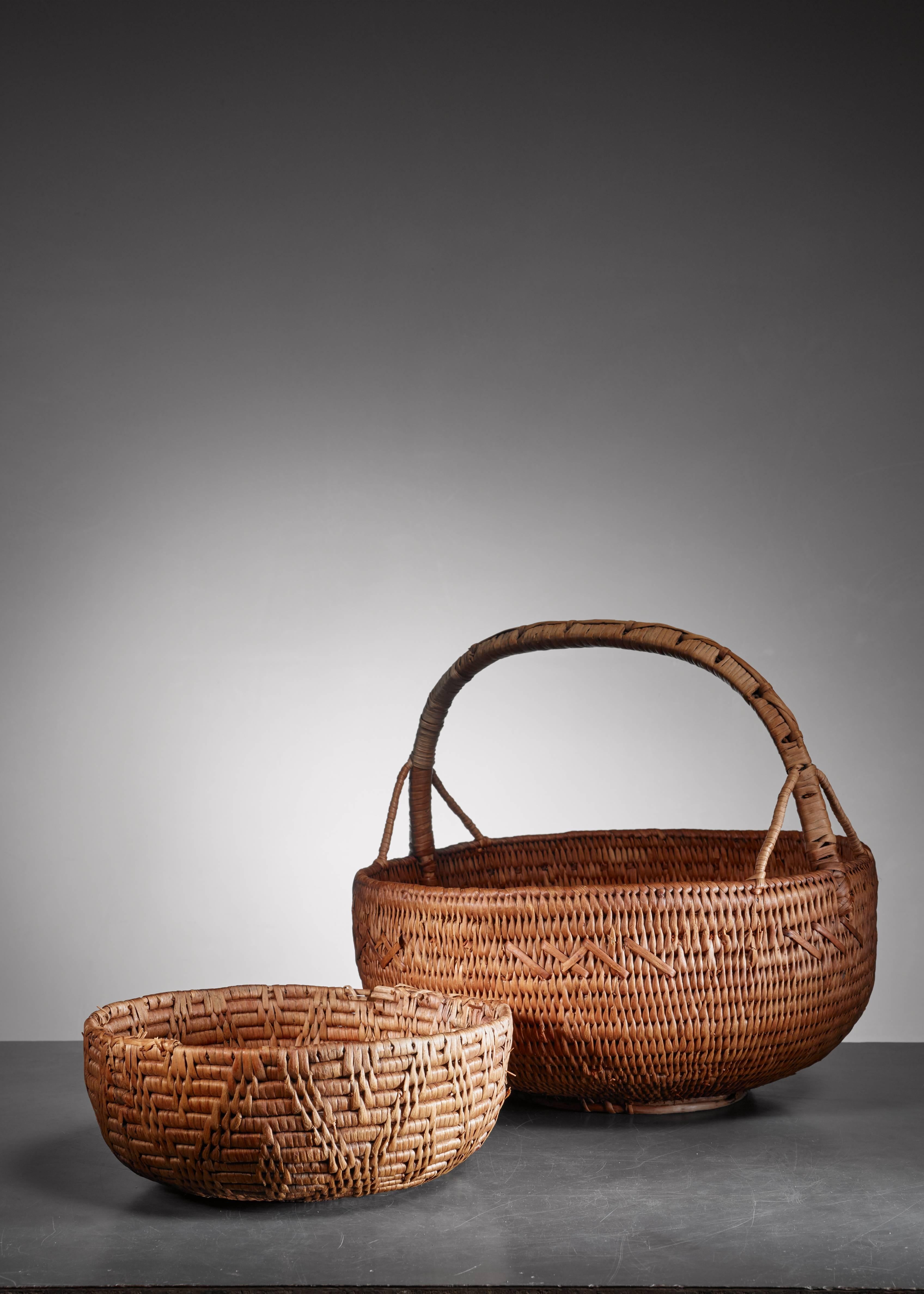 A pair of Swedish Folk Art baskets, made of woven twigs and birch bark.

The measurements stated are of the largest basket with a handle. The smaller piece has a 31 cm diameter and is 12 cm high.
   