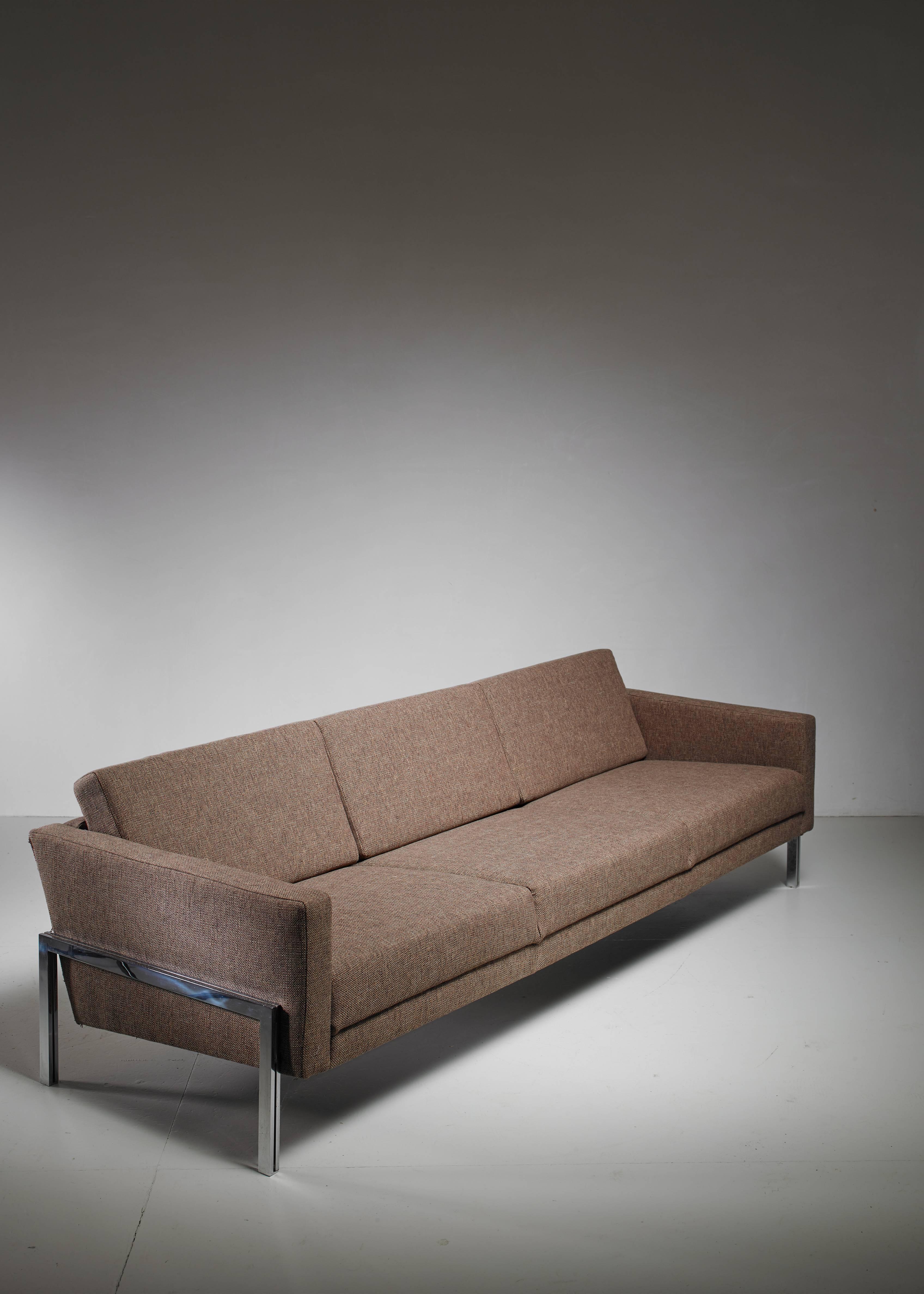 A three-seat sofa by Swiss designer Kurt Thut. The sofa has a metal frame and is newly upholstered in brown grey fabric and in a perfect condition.

We have a matching pair of lounge chairs available.