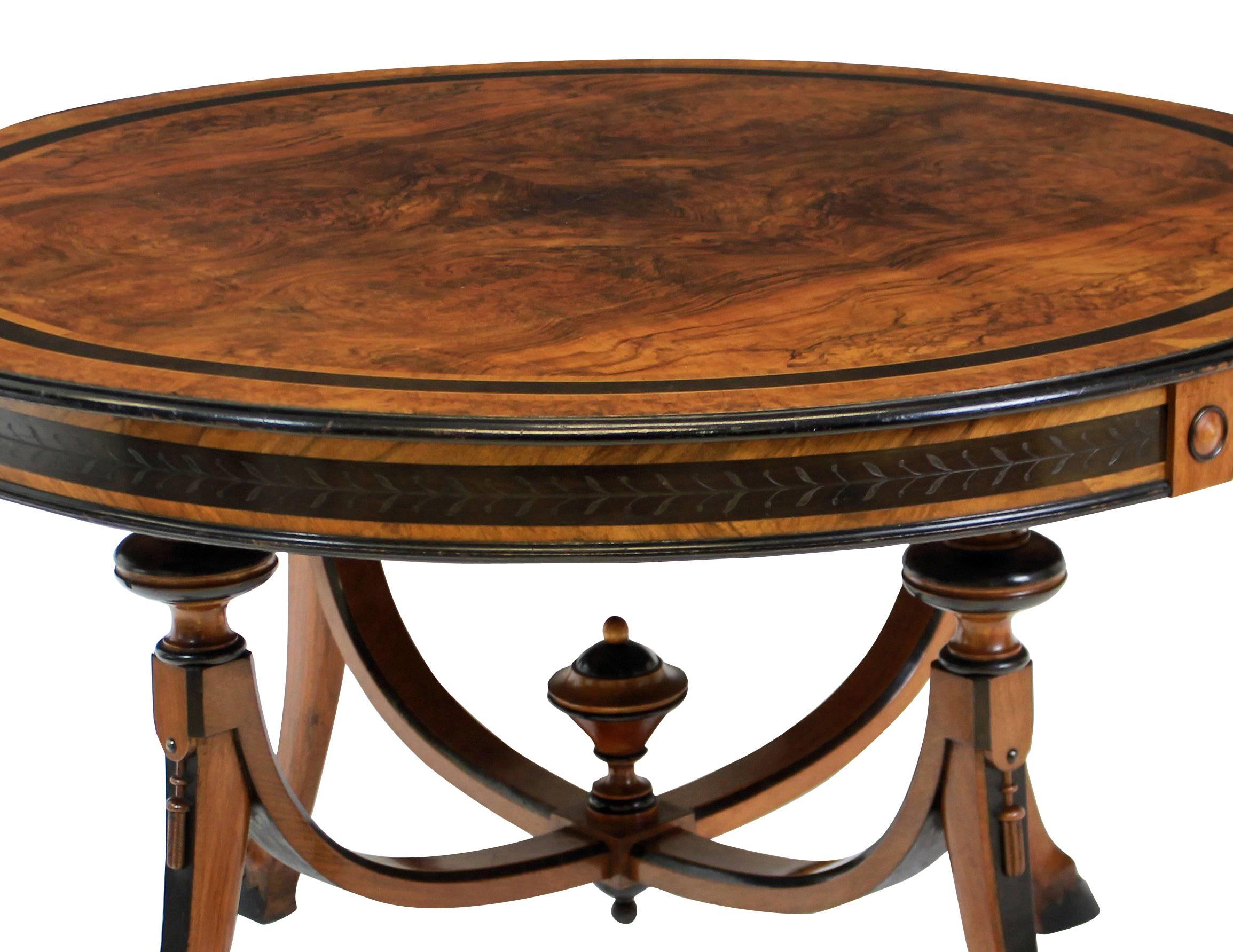 A fine French walnut and ebony circular sofa table with beautiful figuring and detail on hoof feet.
 