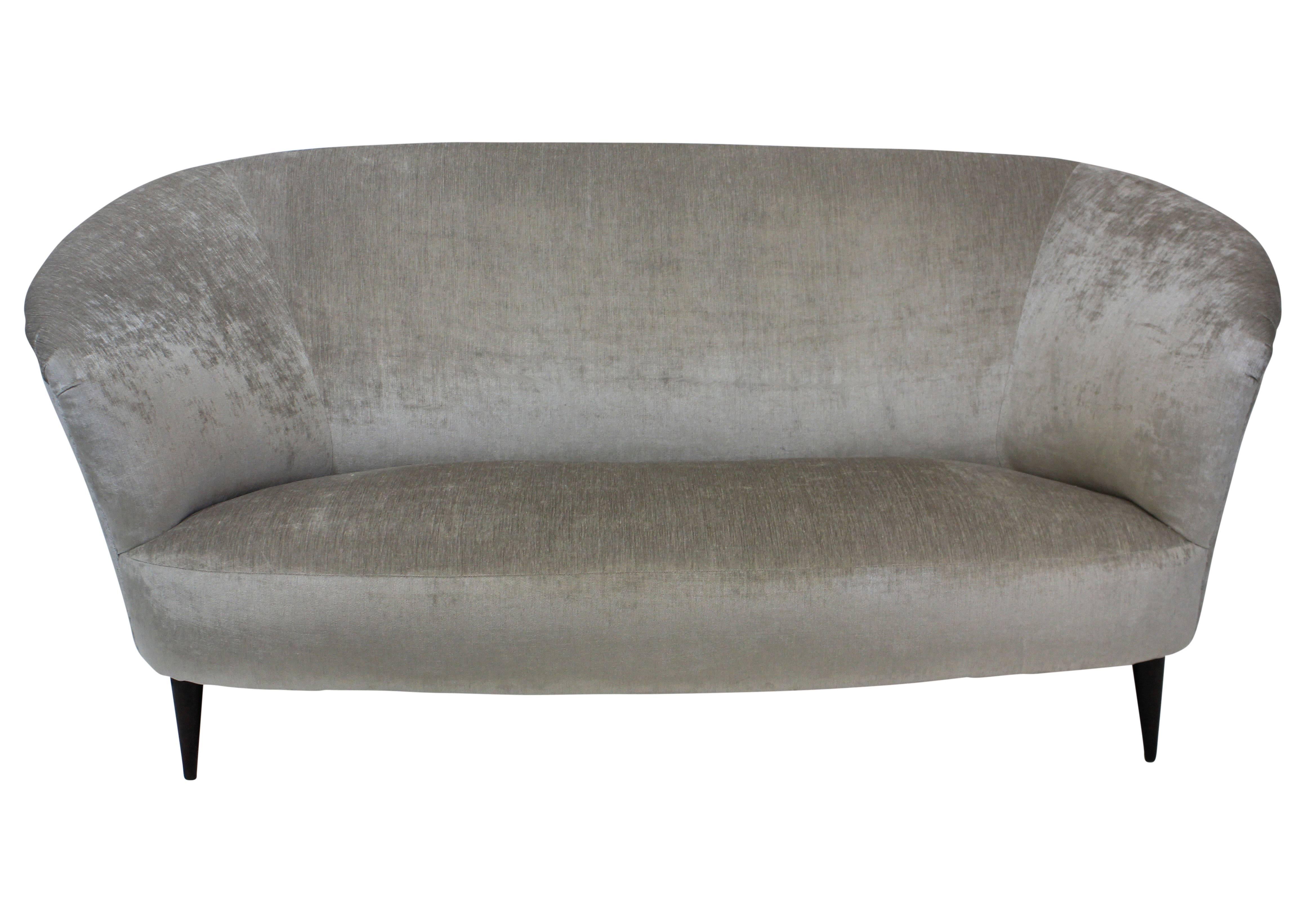 An Italian curved sofa by Ico Parisi of beautiful design and comfort. Newly upholstered in silver-grey velvet.