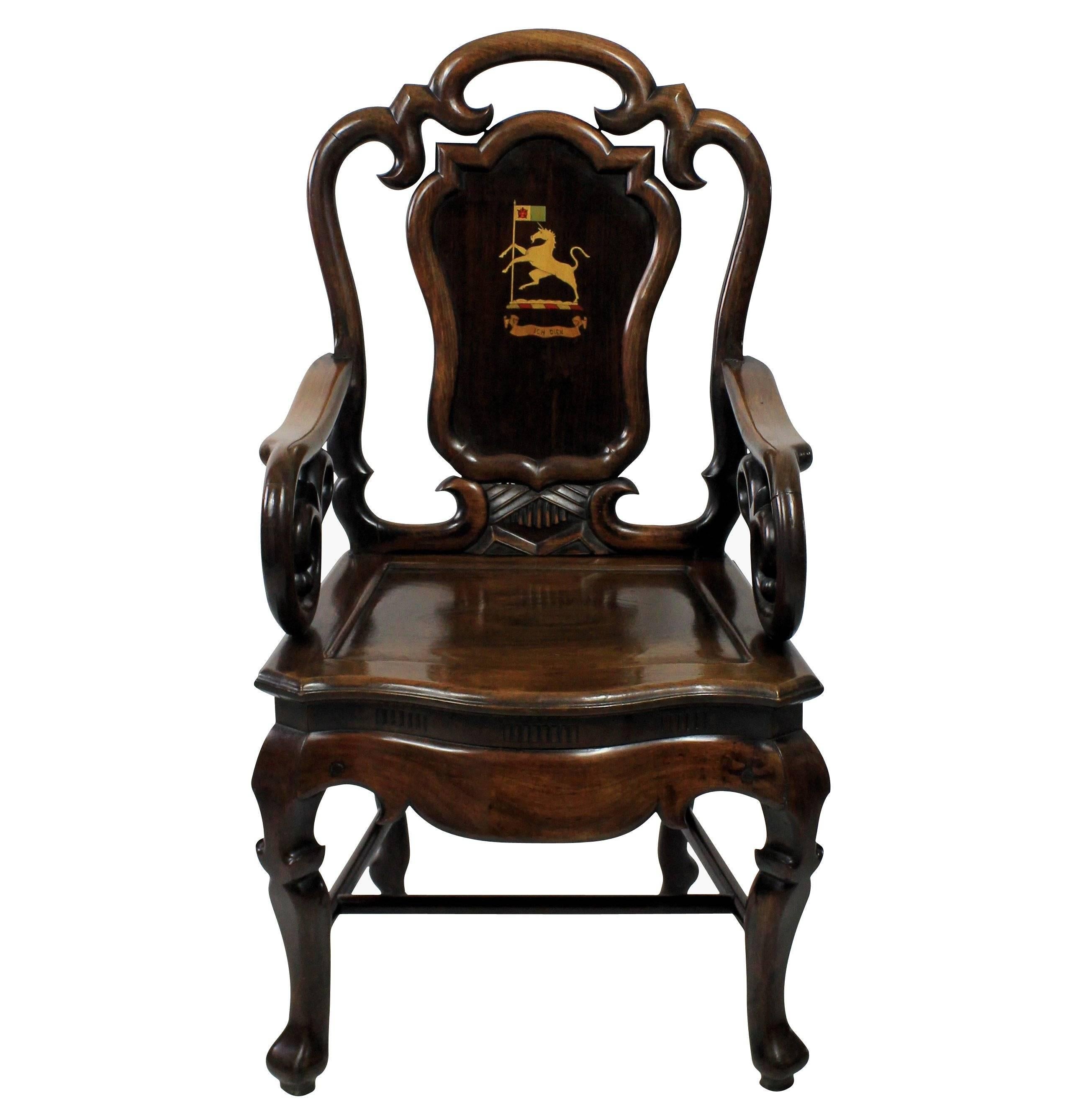 A pair of Anglo Chinese armchairs of fine quality, of unusual design in solid rosewood. Of good heavy weight and bearing an armorial crest associated with a Prince of Wales 'Ich Dien'.
 