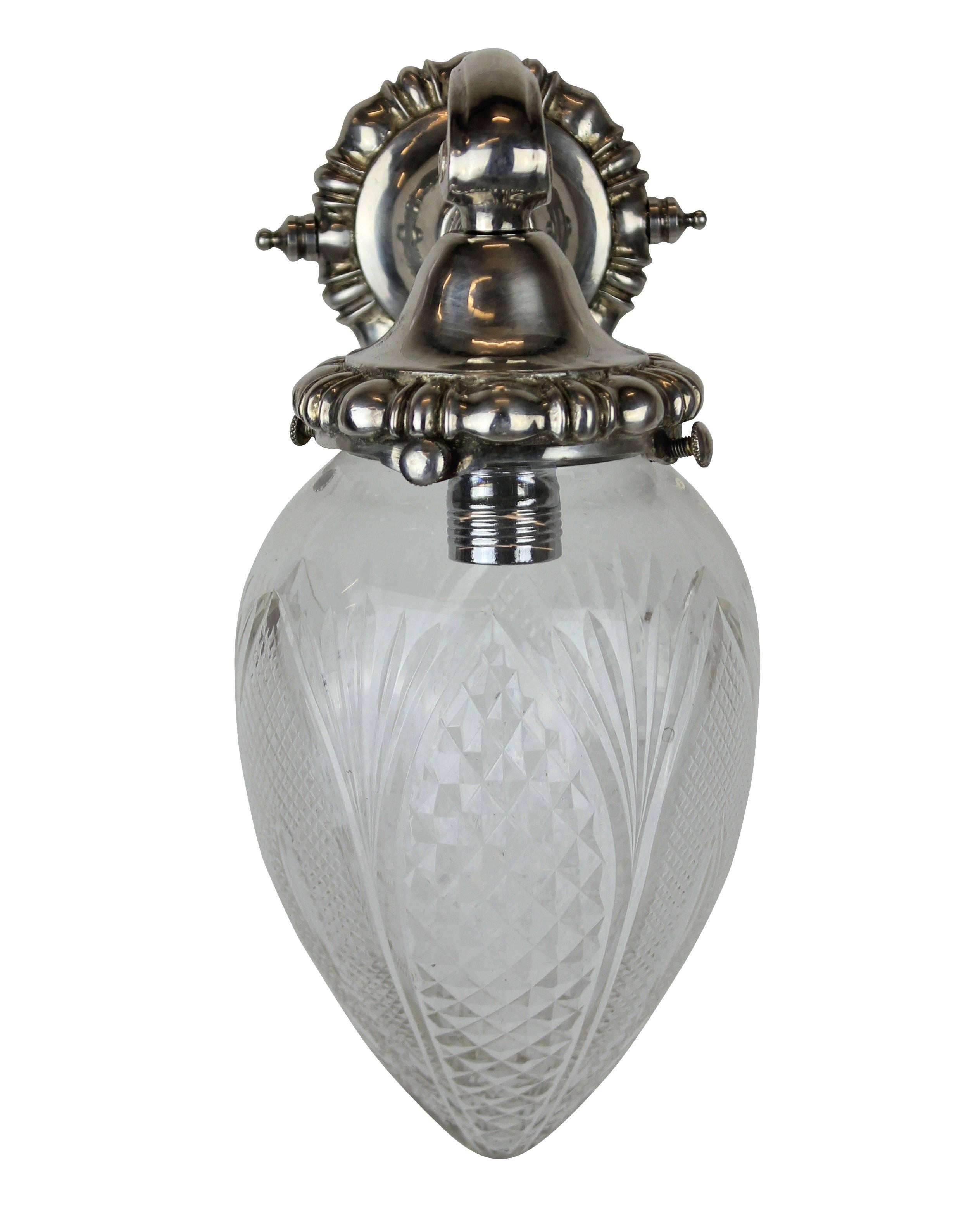 A set of six French silver wall bracket sconces with cut glass globes.
 