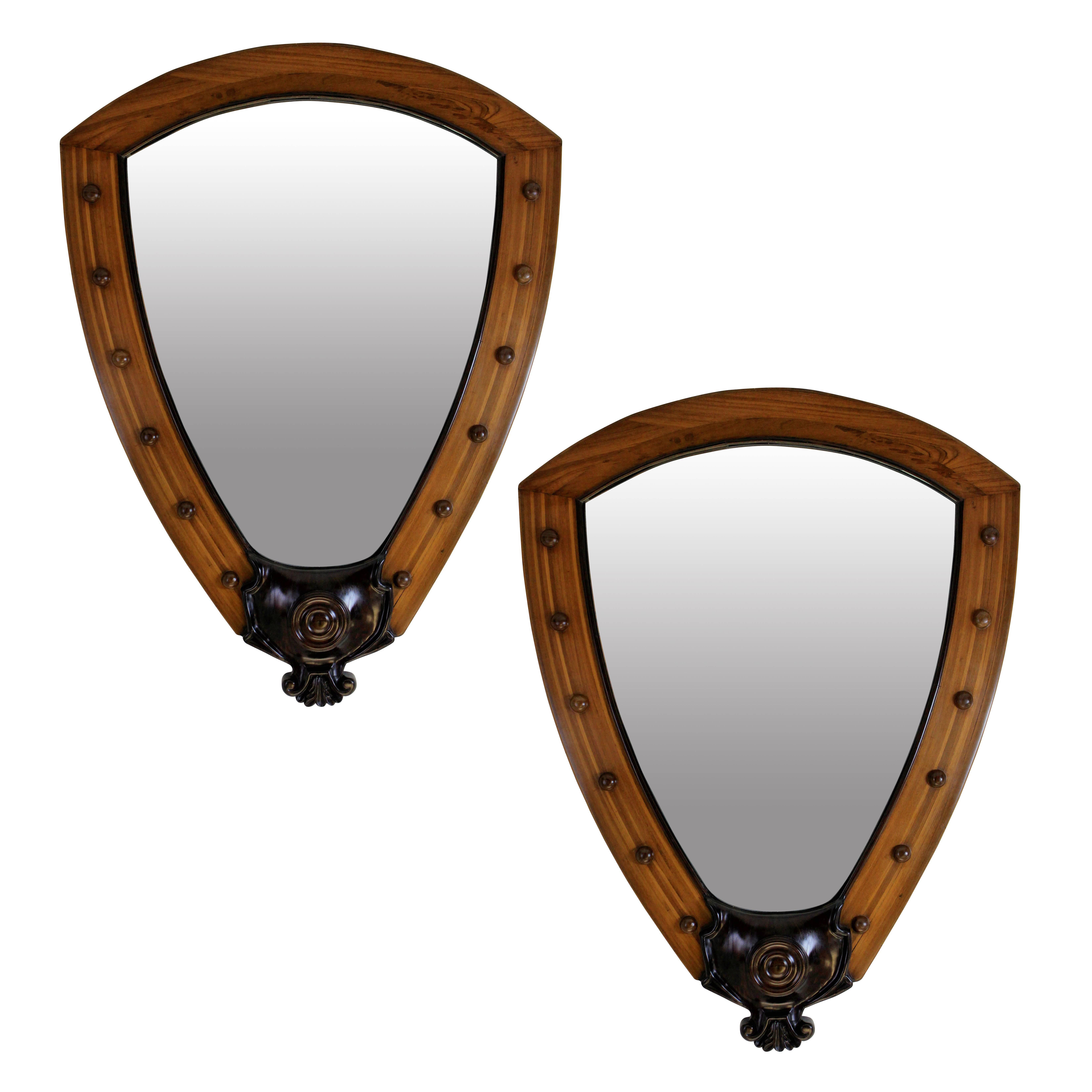 A rare pair of English mirrors of large proportions, from a white star line ocean liner interior. The quality and weight is matched by the very unusual shape and design. They are in solid teak and rosewood, with oak backs. Original mirror plates.
  
