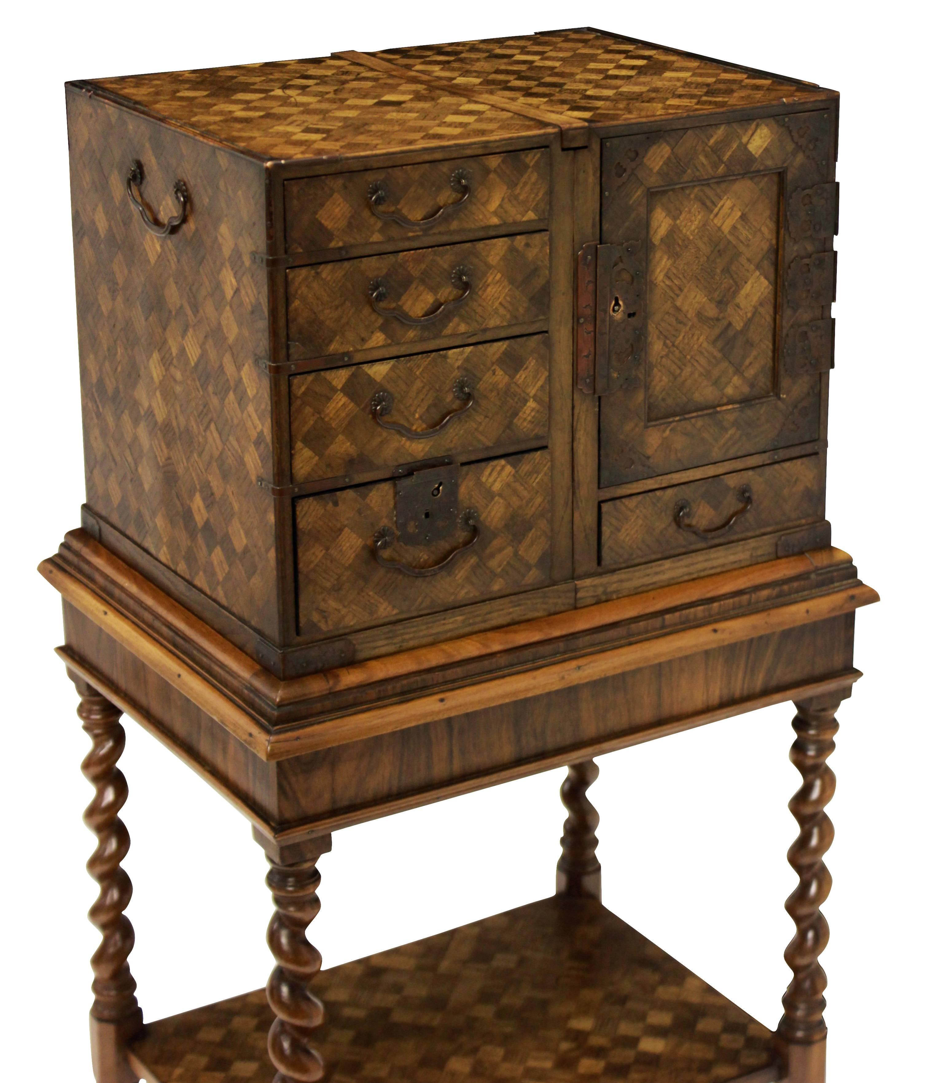 An English William & Mary chest on stand in walnut and oak, with a Japanned interior of red & black lacquer.