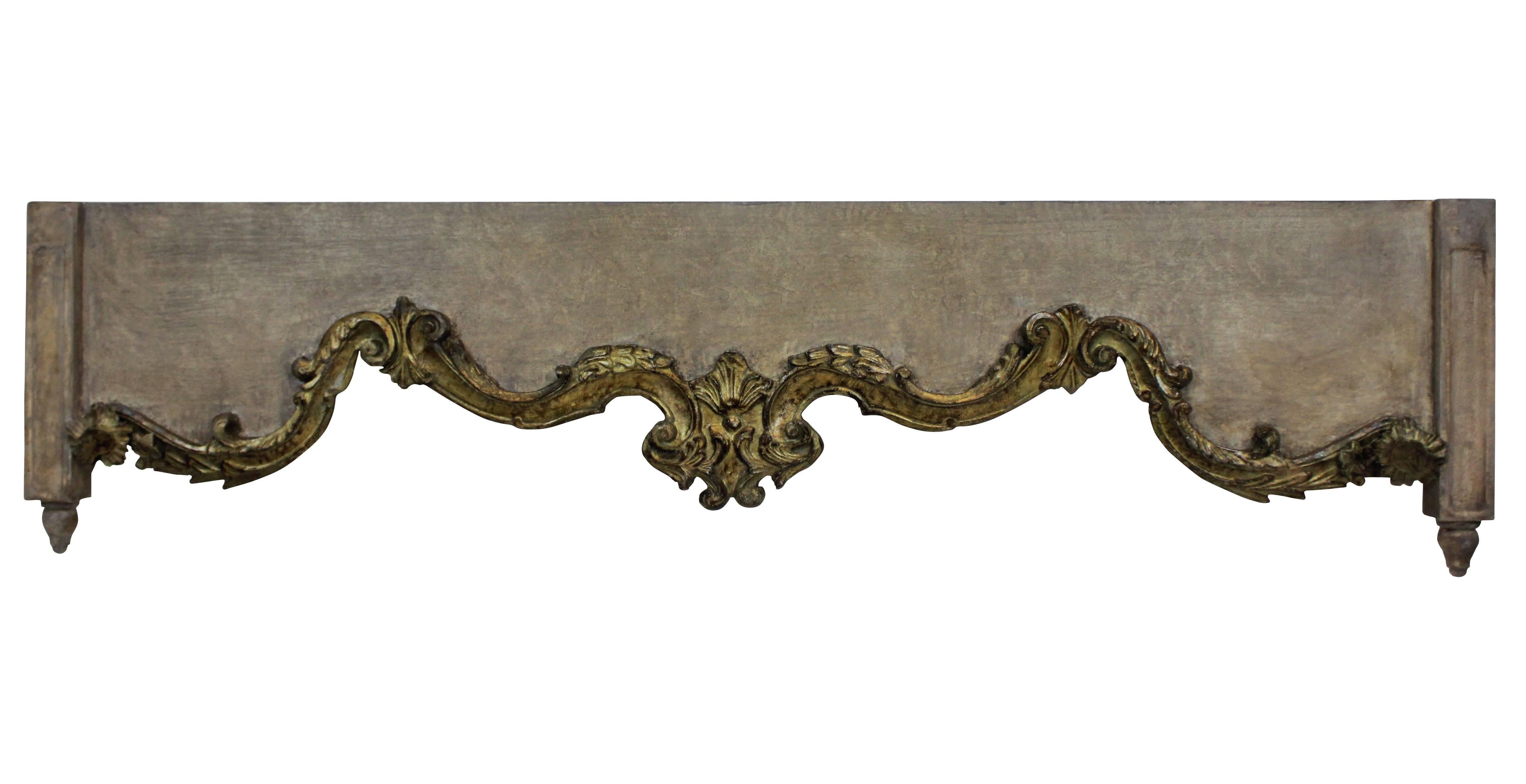 A set of four English carved, distressed painted and gilded pelmets.
  