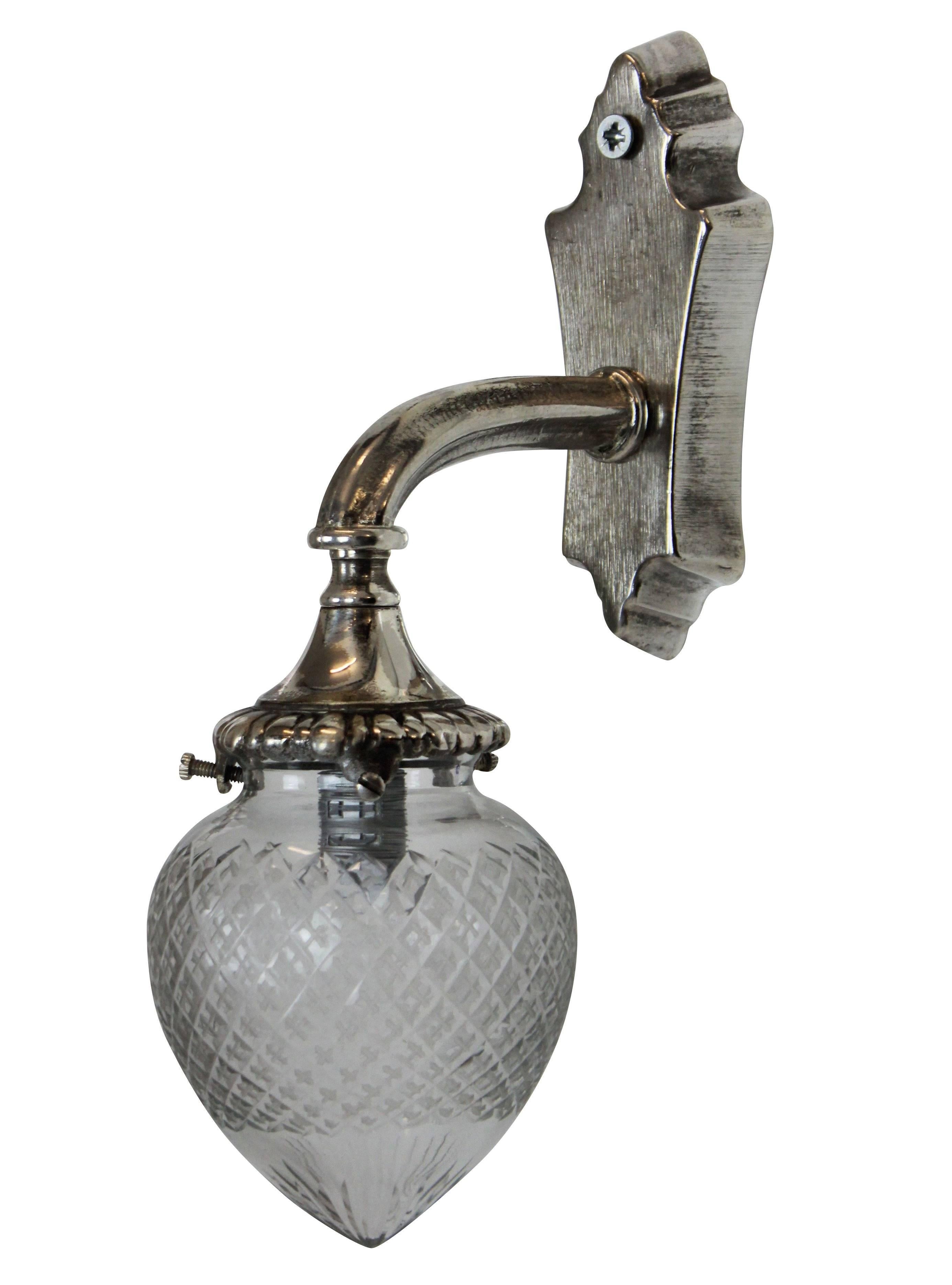 A set of eight French silver wall bracket sconces with cut-glass globes.