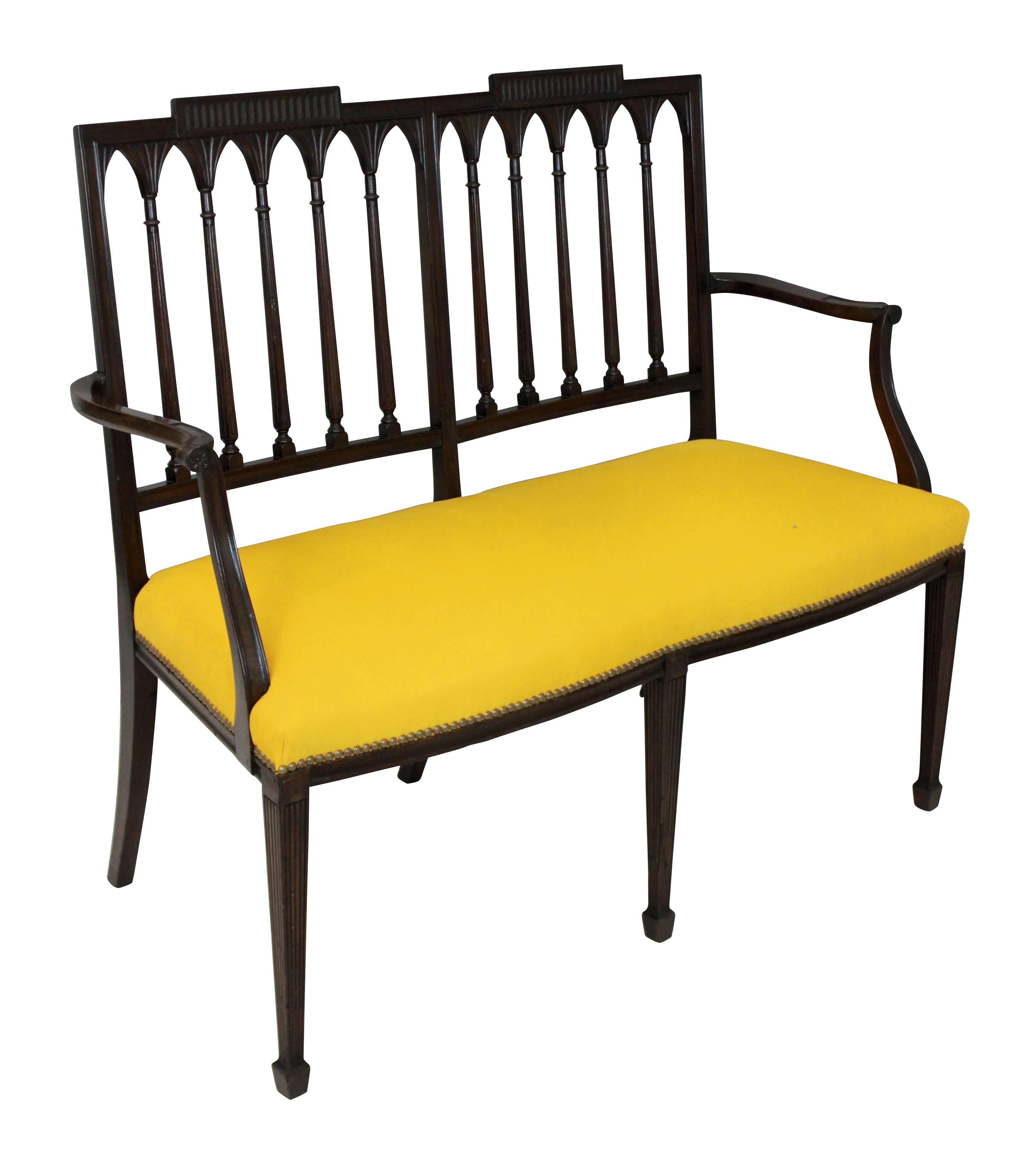 A mahogany Federal settee in the manner of Slover & Taylor of New York with a double tablet back, reeded spindles, legs and scrolling arms. Newly upholstered in canary yellow corduroy.

 Measures: 98cm high (back) x 46cm high (seat) x 101cm wide x