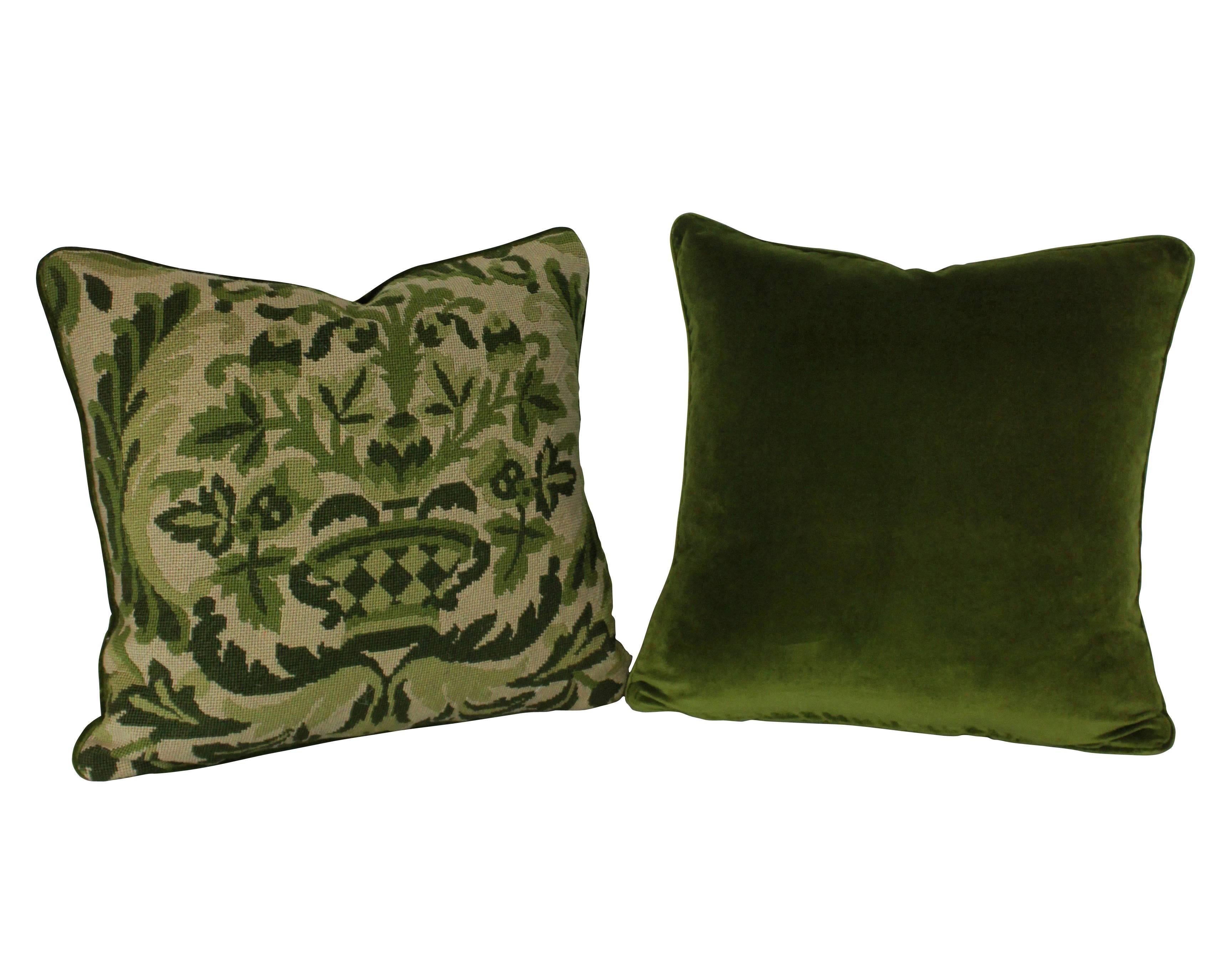 A set of four French 19th century needle point cushions of florid design in greens, with velvet backs and feather pads.
 