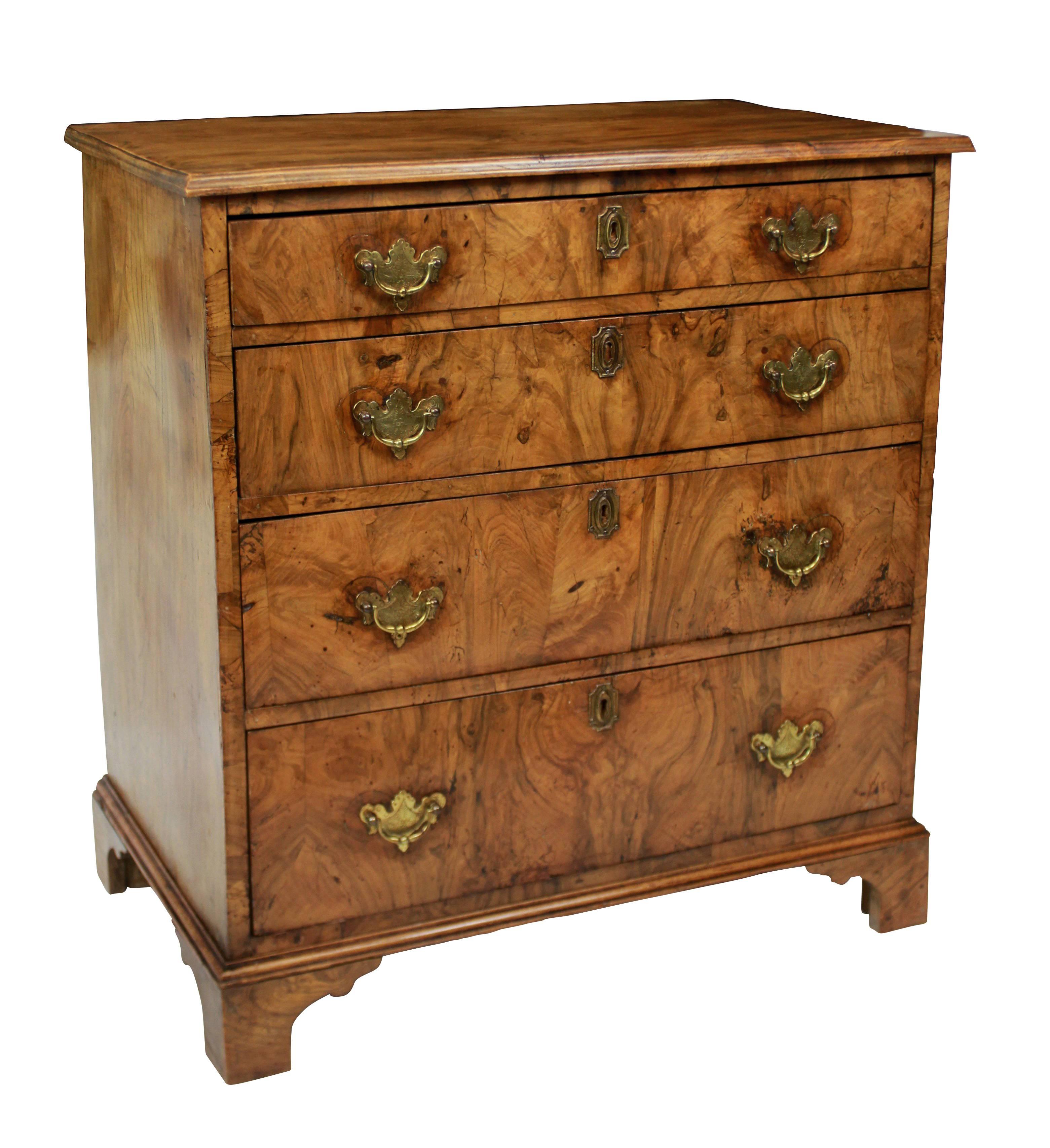 An English chest of small proportions with elm top and sides and a beautiful walnut front, with brass fittings.

 