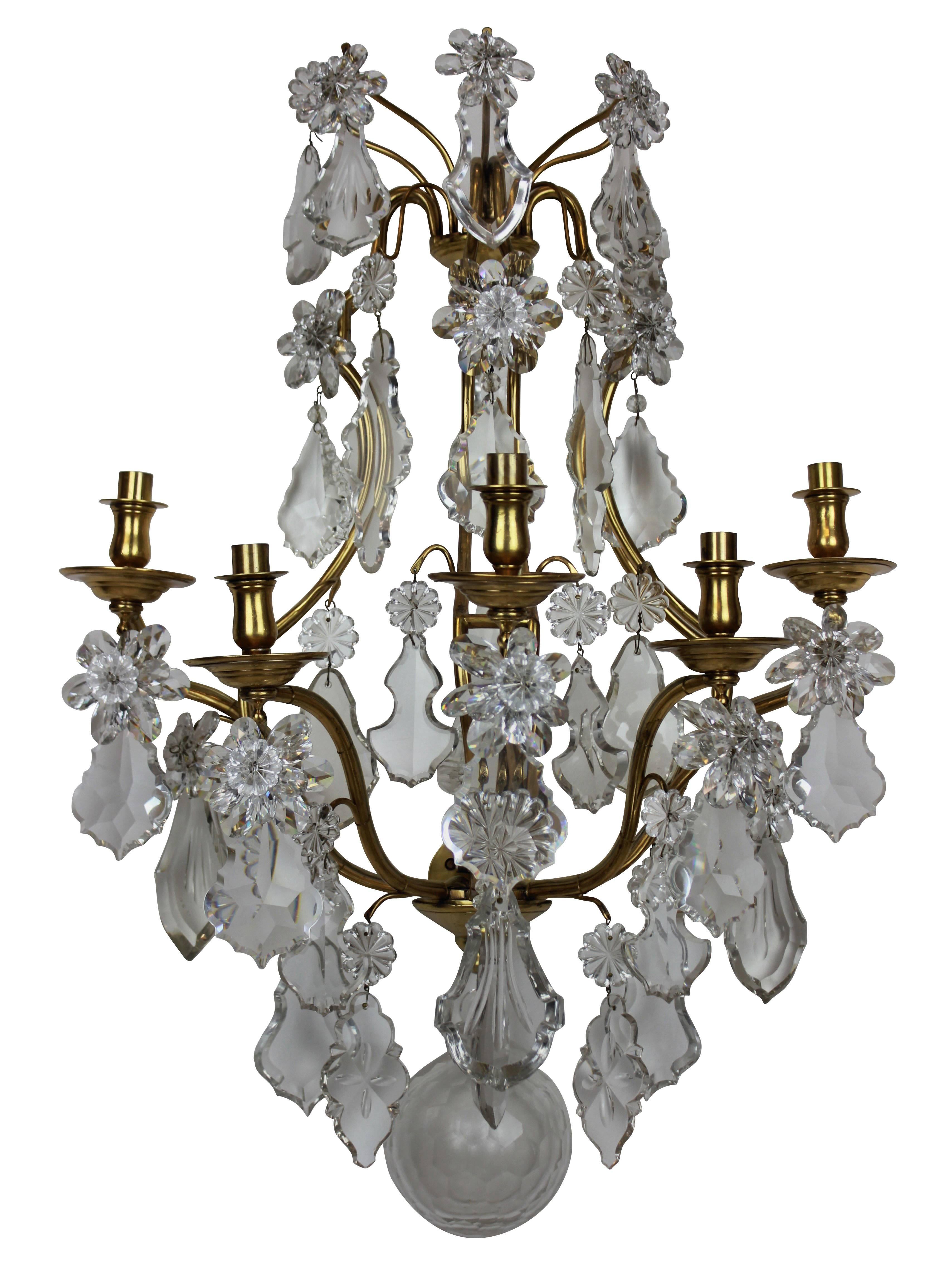 A pair of large ormolu and cut-glass wall sconces by Baccarat of Paris, en suite with a chandelier.

 
