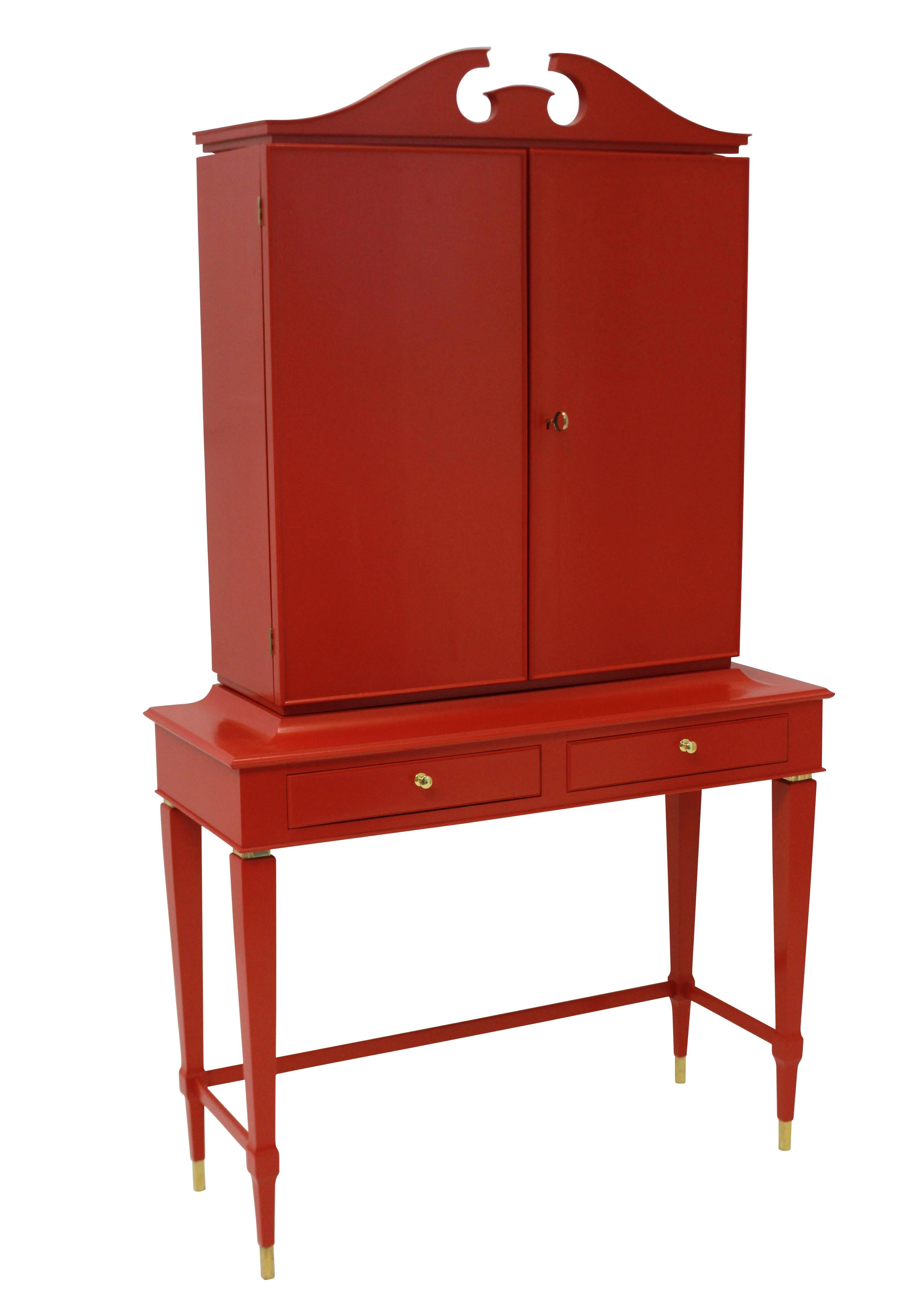 An Italian architectural bar cabinet of fine quality by Paolo Buffa. In red lacquered rosewood, with a fitted interior, and two frieze drawers.