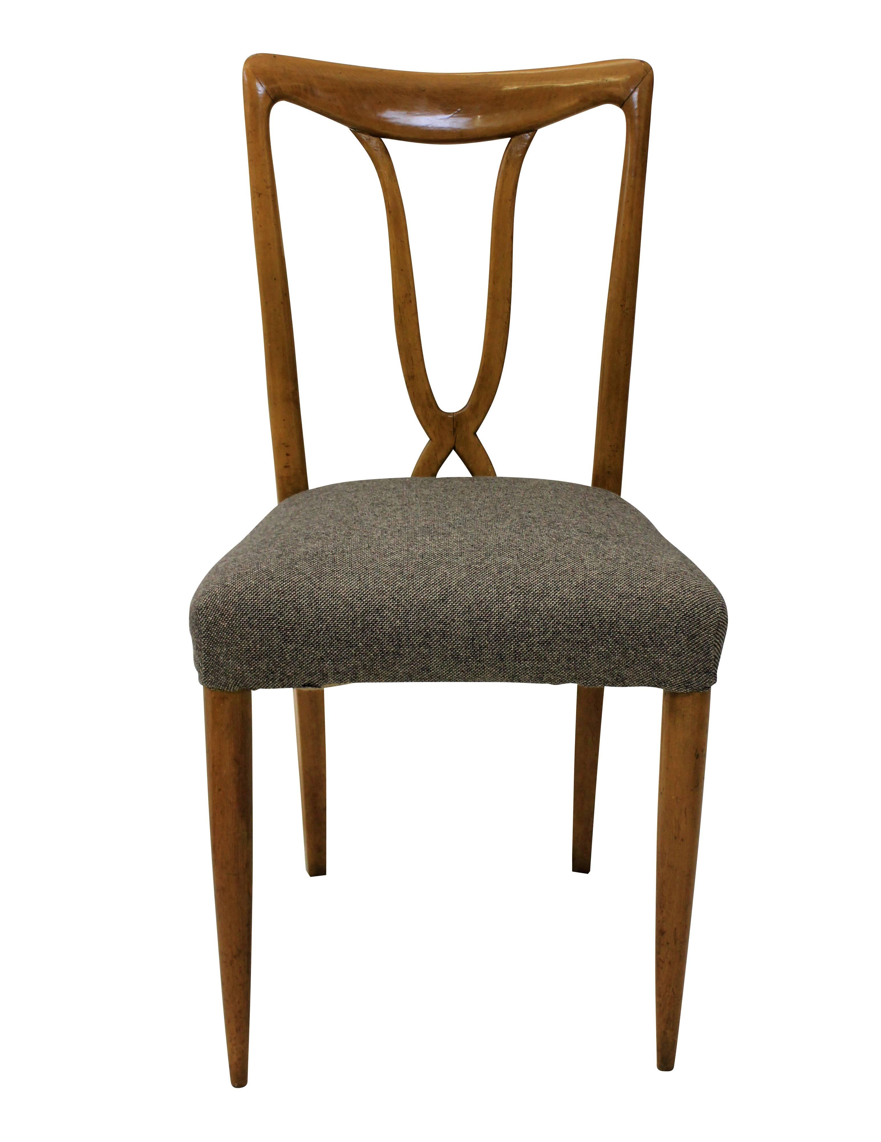 A set of six Italian dining chairs of stylish design in cherrywood. With sculptural backs and newly upholstered in wool.