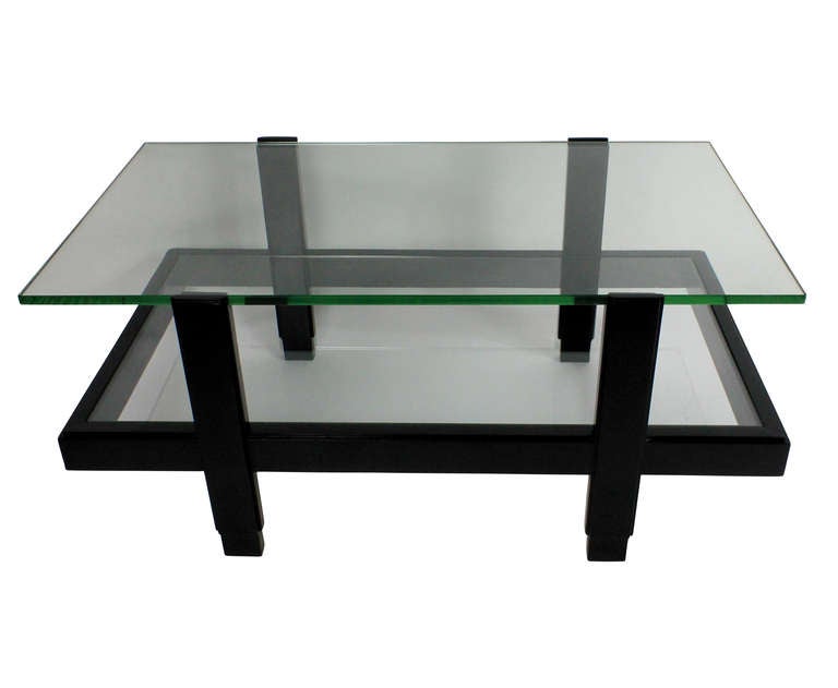 An Italian occasional table comprising two glazed tiers in black lacquered hardwood.