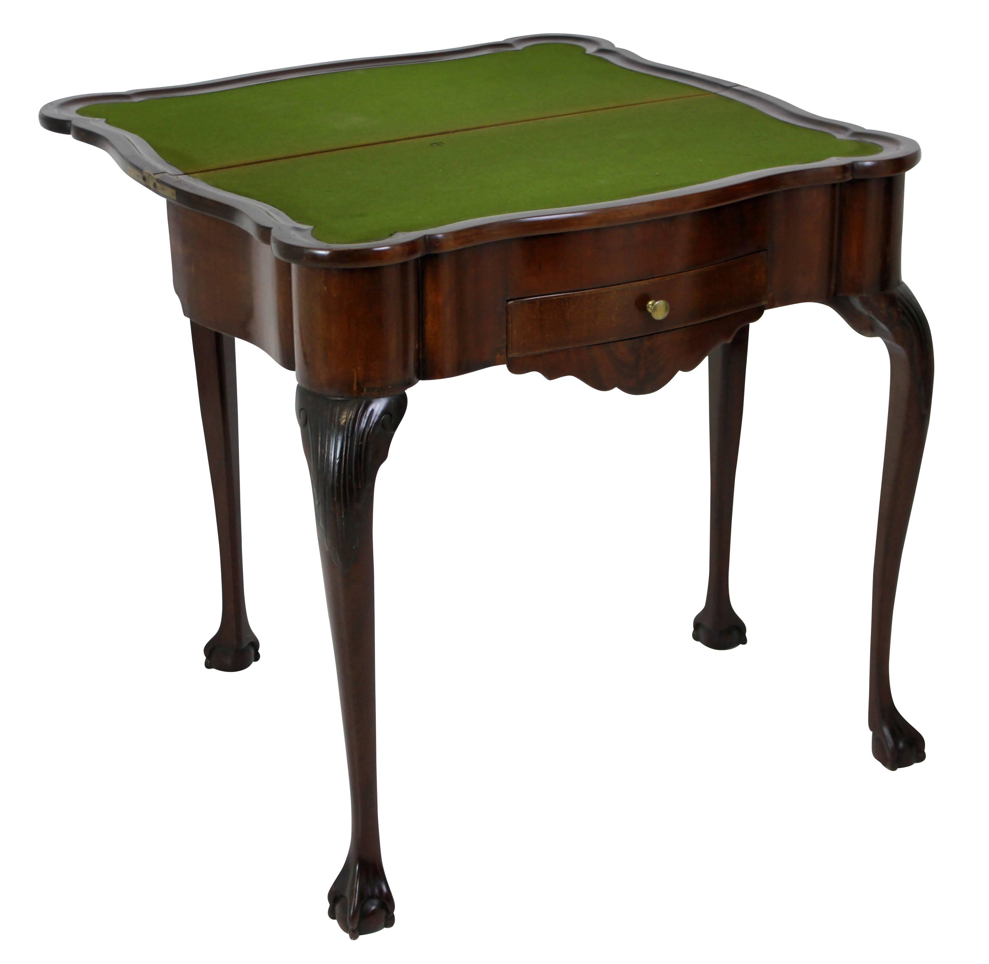 A George II Irish games table in mahogany, with card drawer, fitted interior and a folding lid with baize.
 
