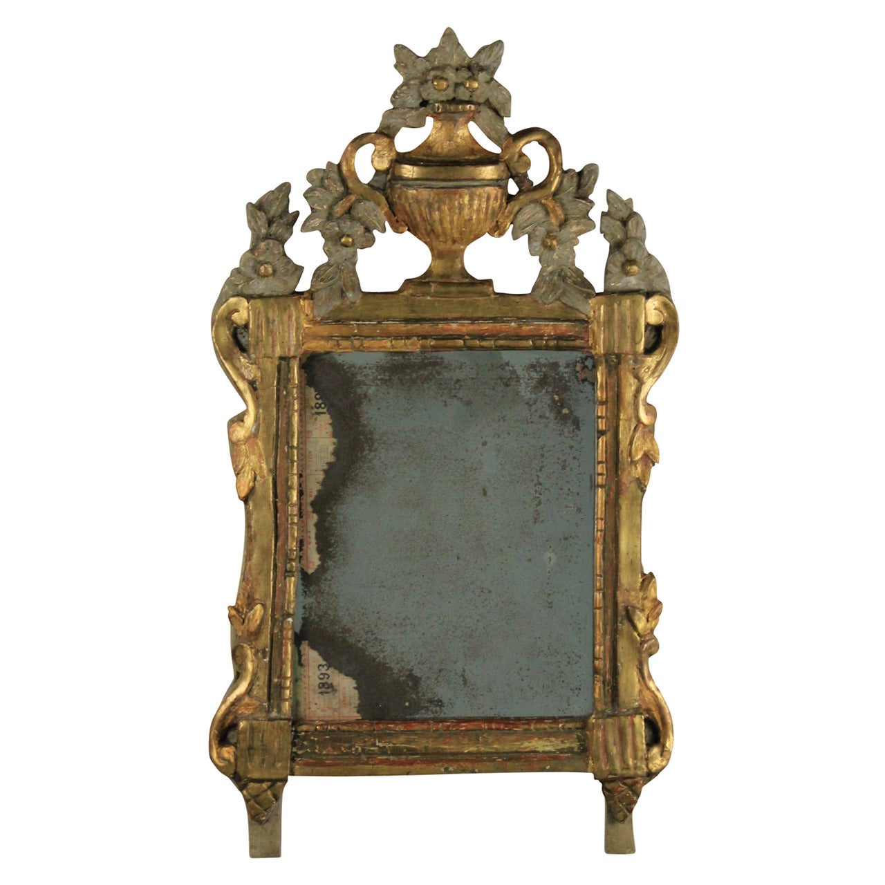 A charming little French Provincial mirror with a water gilded and painted frame with a floral cartouche. Original mercury plate.