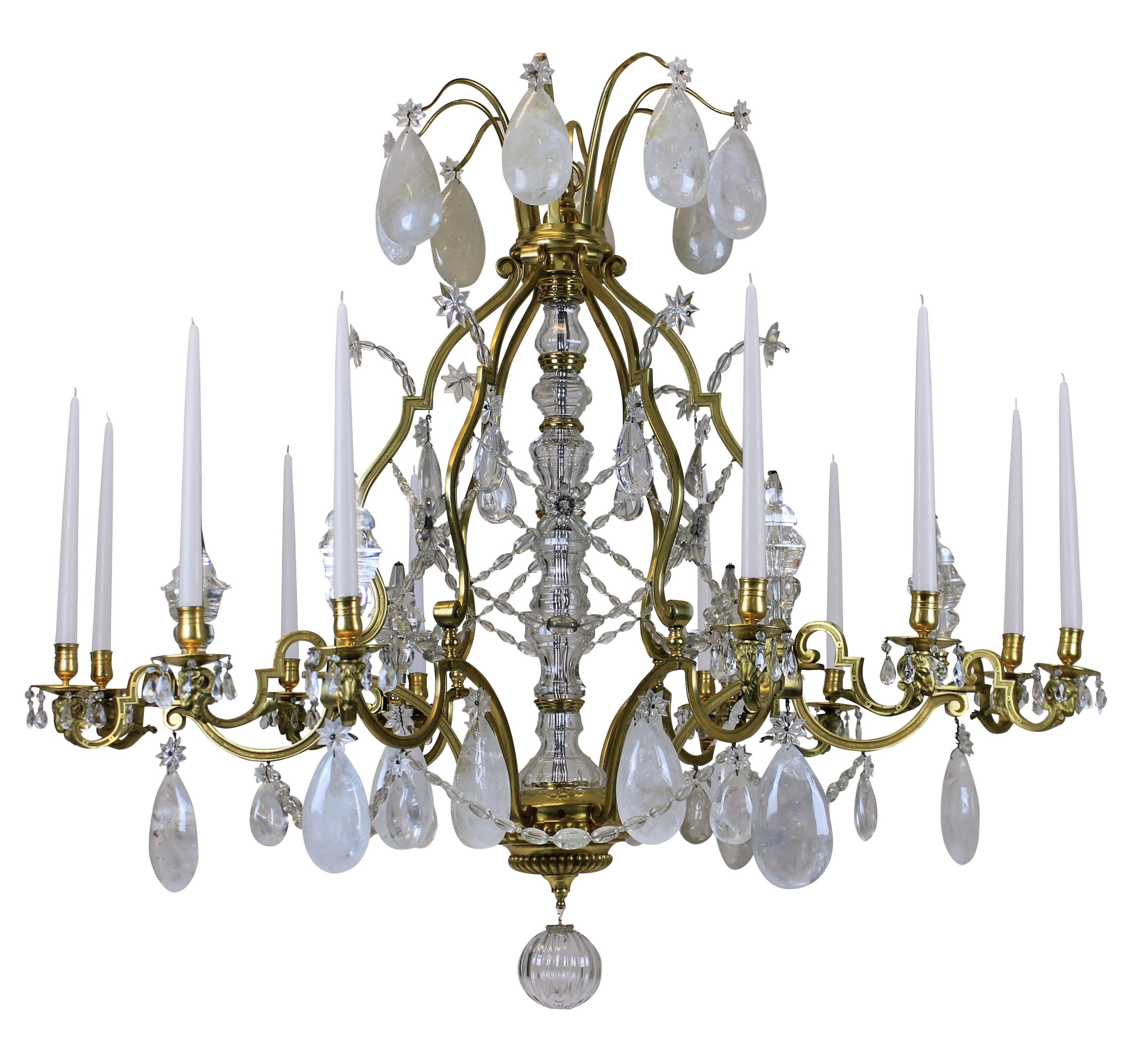 This Louis XIV chandelier is monumental in scale and is of the highest quality of mercury gilded bronze and hung with rock crystal. Of superb proportions and detail. With ram's head decoration to each arm, of which there are twelve in total, with