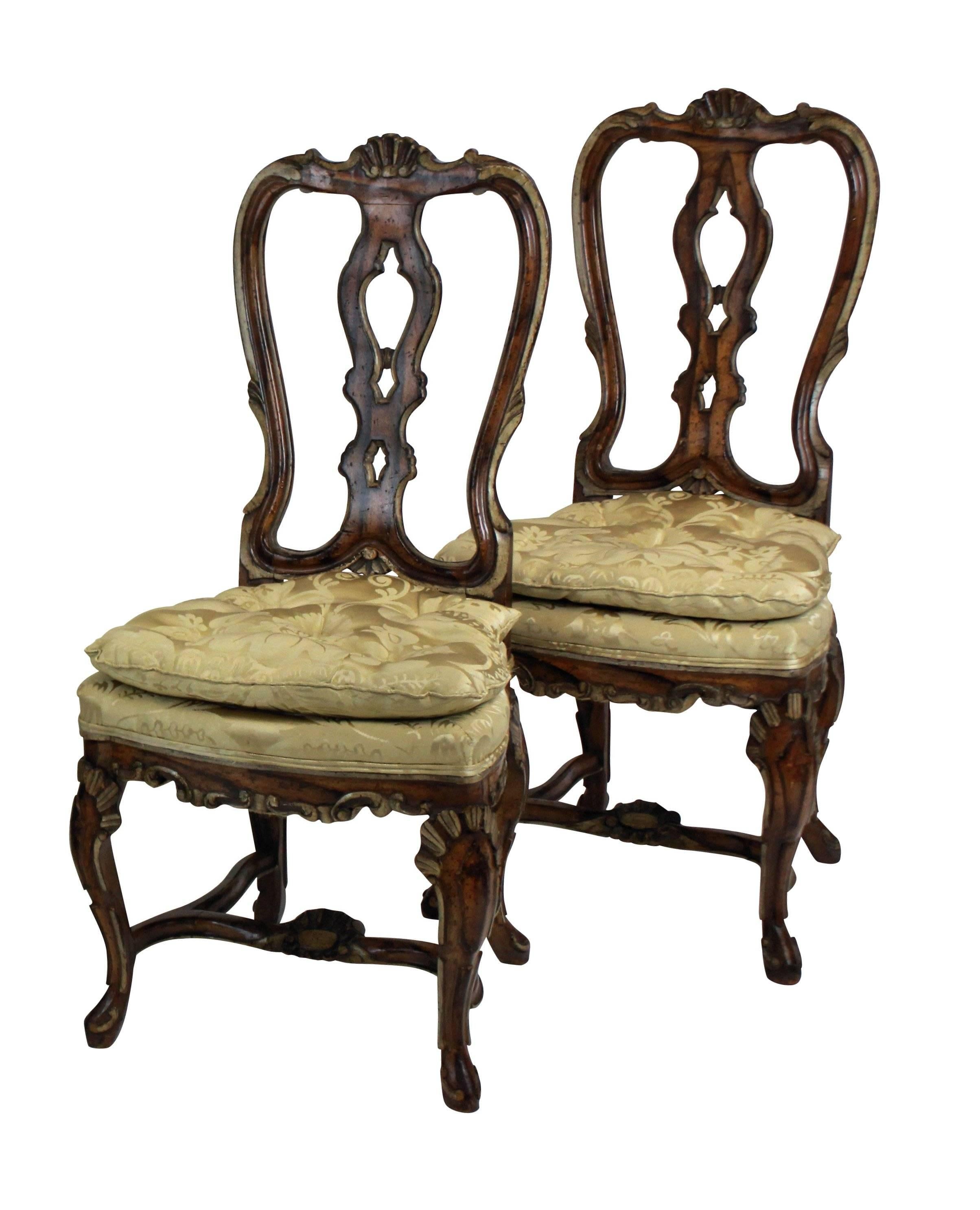A set of four fine high back George II dining chairs in faux walnut with painted detail. Beautifully carved with silk damask seats.
 