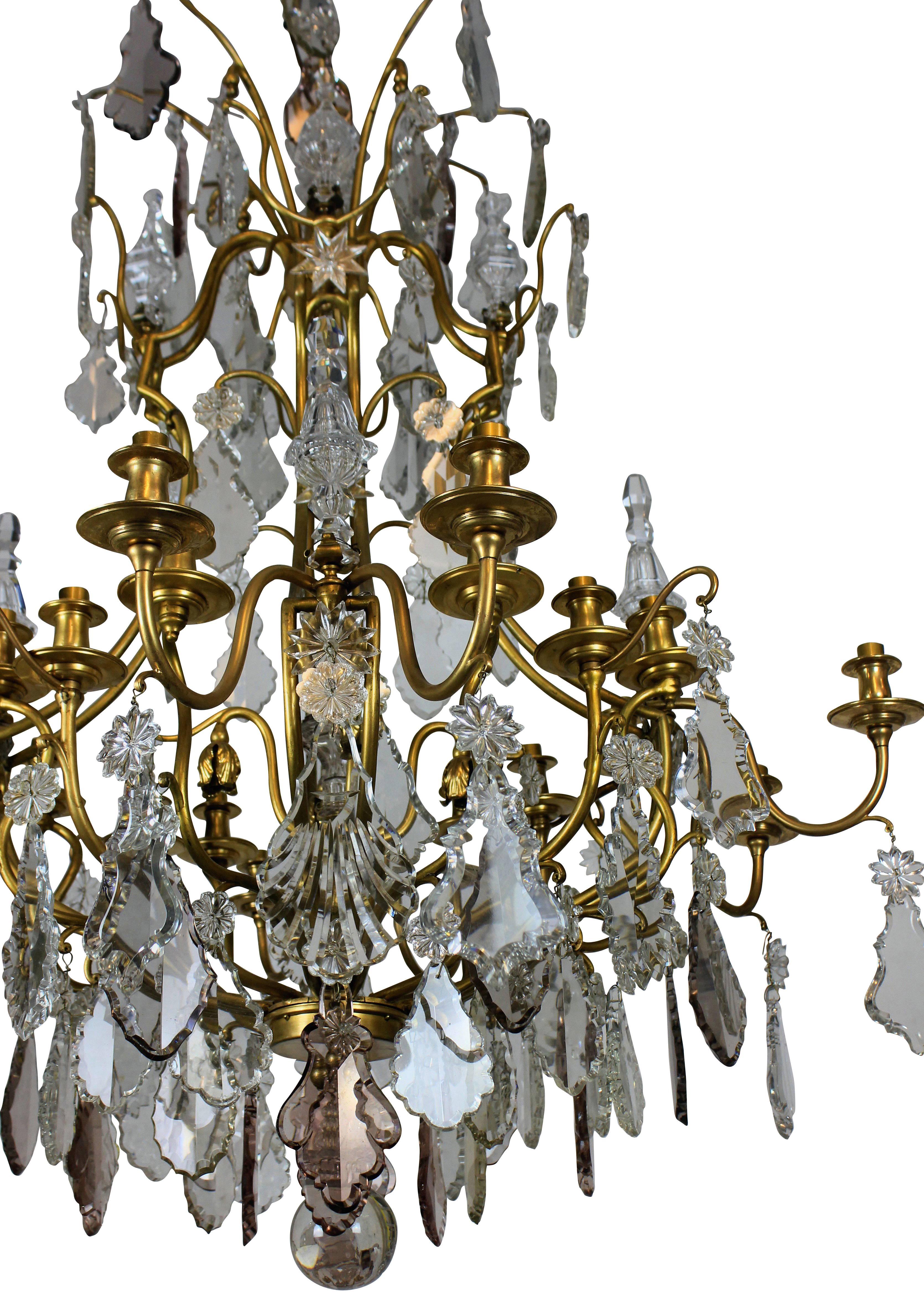 A large ormolu and cut glass cage chandelier by Baccarat of Paris, en suite with a pair of large wall sconces.

  