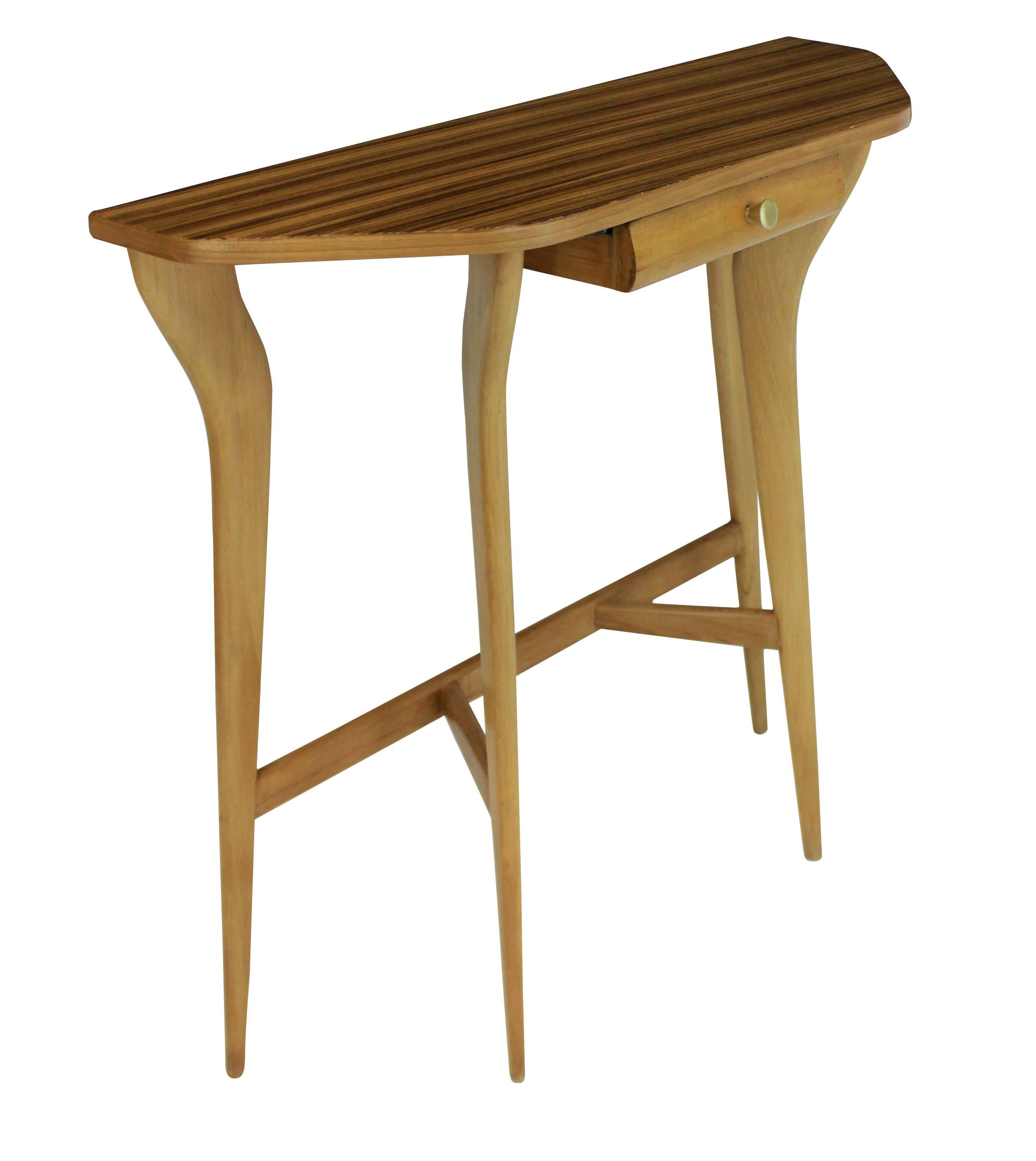 An Italian console table of architectural design in pale wood, with a bleached palisander top.
 